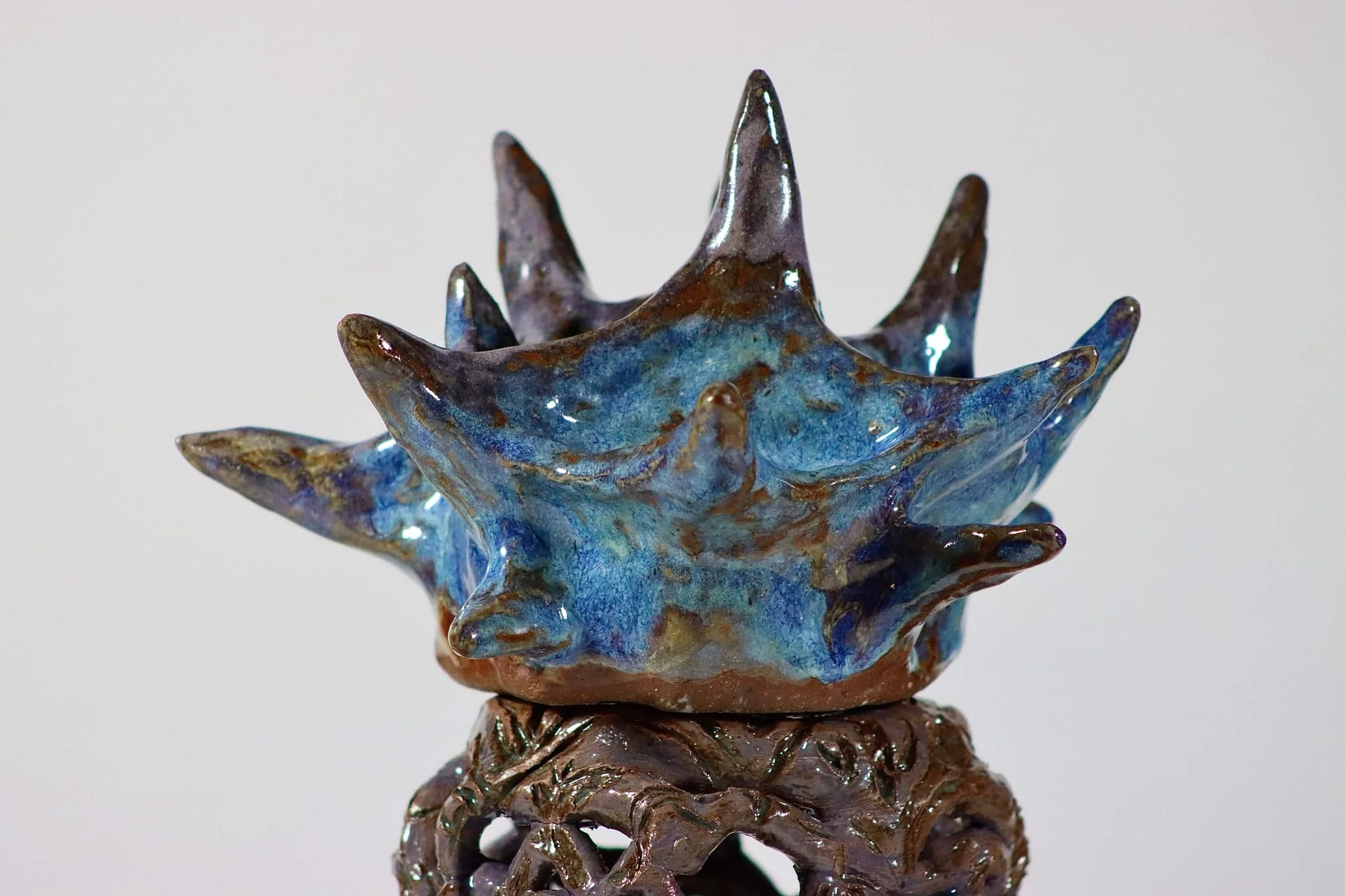 “Weight on your shoulders”, 2025.
Red stoneware clay with sgraffito and purple slip, celadon, purple haze, and cerulean blue heaven glazes.
3" x 11" inches. 
The heavy and hard expectations being weighed on upon your shoulders while holding on to you