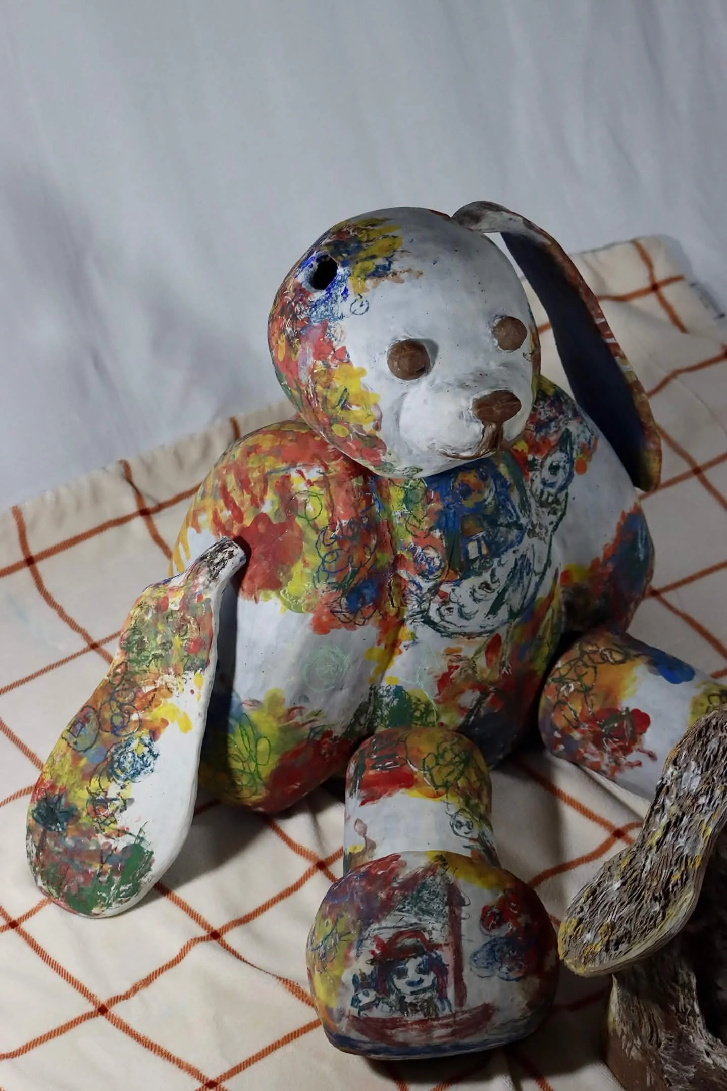 "Repatching My Inner Childhood", 2025. 

Red stoneware clay, Porcelain slip, Underglaze paint and crayons.
22" x 24" and 14" x 8".                                                                
Preserving my precious childhood memories by repatching