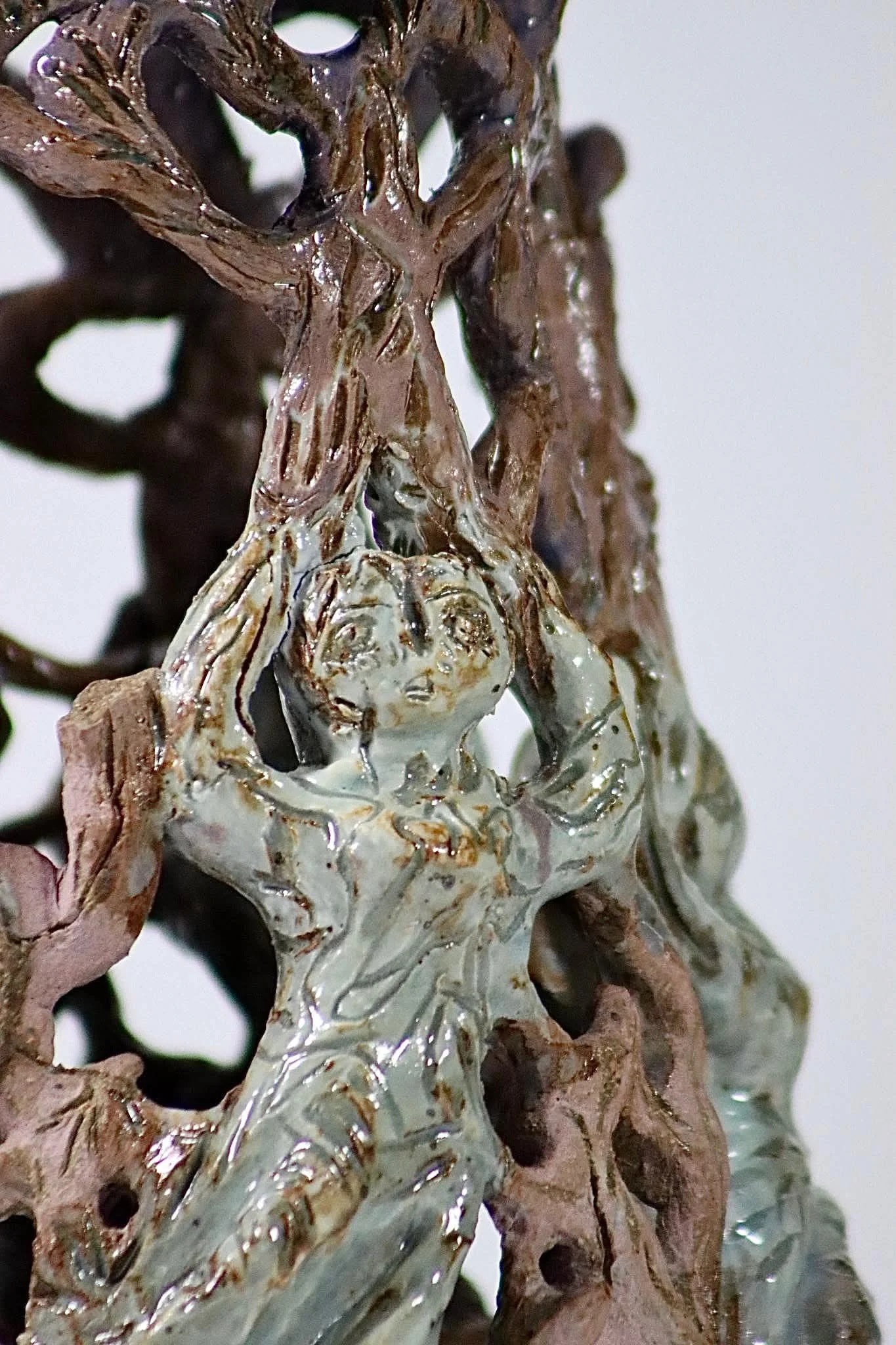 “Weight on your shoulders”, 2025.
Red stoneware clay with sgraffito and purple slip, celadon, purple haze, and cerulean blue heaven glazes.
3" x 11" inches. 
The heavy and hard expectations being weighed on upon your shoulders while holding on to you