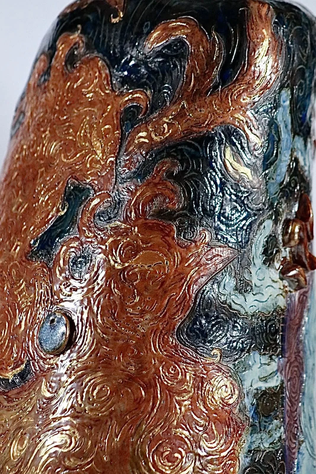 “Rebirth”, 2025. Red stoneware clay with sgraffitto,  black and porcelain slips, malcolm shino, red irwing, peach bloom 2, cuba's beaches, purple haze, and gold acrylic paint.
9" x 23" inches. 
The ceramic vase displays a narrative story of rising fr