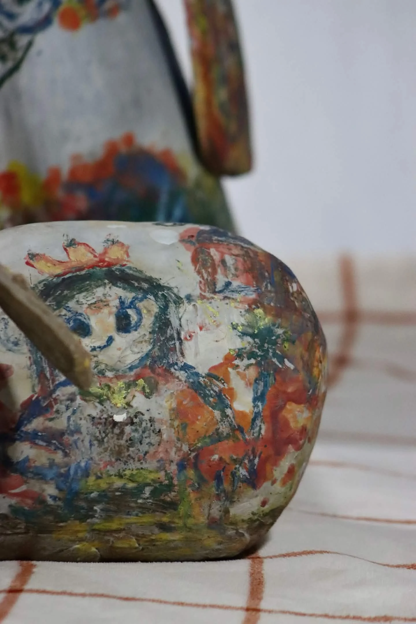 "Repatching My Inner Childhood", 2025. 

Red stoneware clay, Porcelain slip, Underglaze paint and crayons.
22" x 24" and 14" x 8".                                                                
Preserving my precious childhood memories by repatching