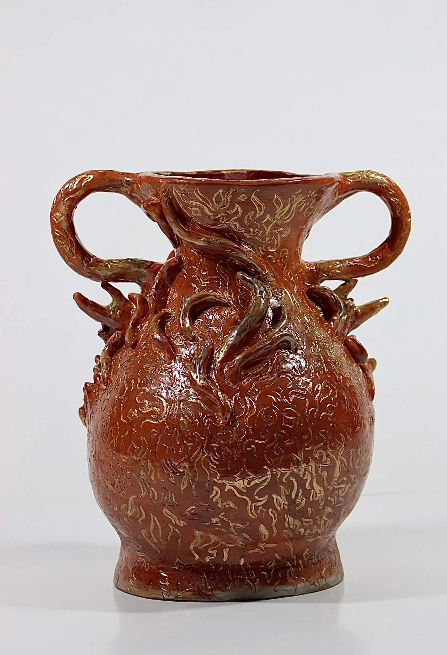 "Frail Spirit Burning Brighter", 2026. Glazed Red Stoneware with porcelain slip and acrylic paint. 9" x 16" inches. A ceramic vessel entails a docile soul in the form of a rabbit spreading its luminous flames. 