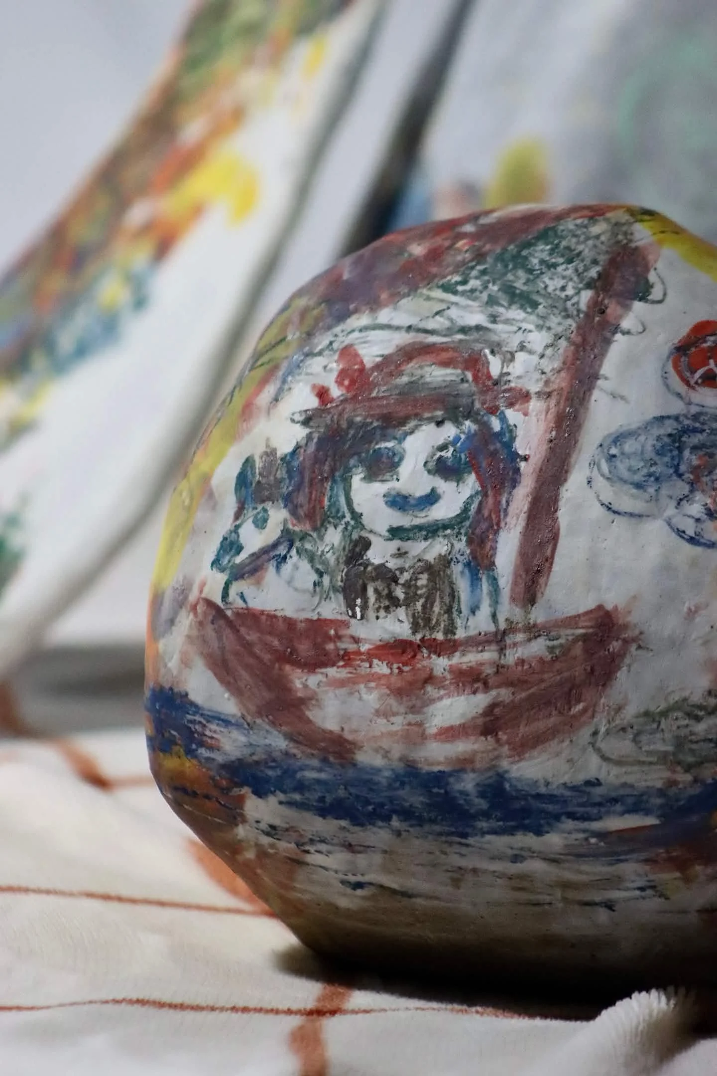 "Repatching My Inner Childhood", 2025. 

Red stoneware clay, Porcelain slip, Underglaze paint and crayons.
22" x 24" and 14" x 8".                                                                
Preserving my precious childhood memories by repatching