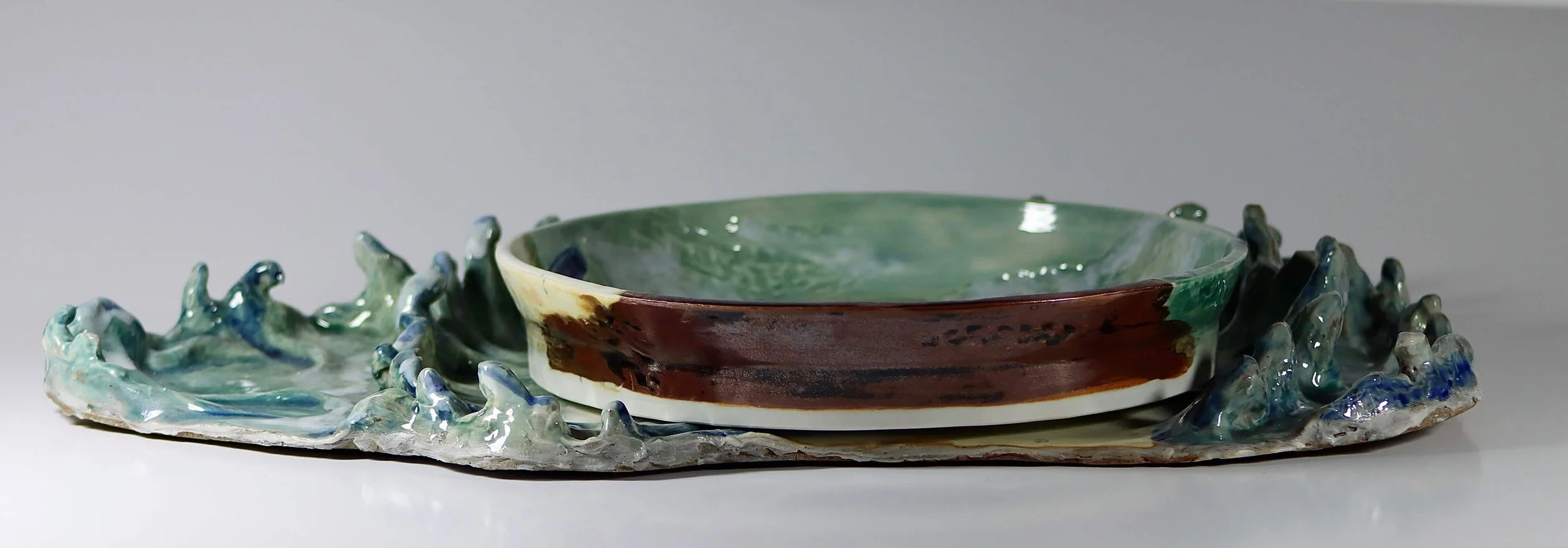 "My Rushing Waves of Culture III" 2026.  Glazed Porcelain. 11" x 8" inches.  Part of a series.  A ceramic plate of Miami Beach's shoreline on a tray in the form of ocean waves.