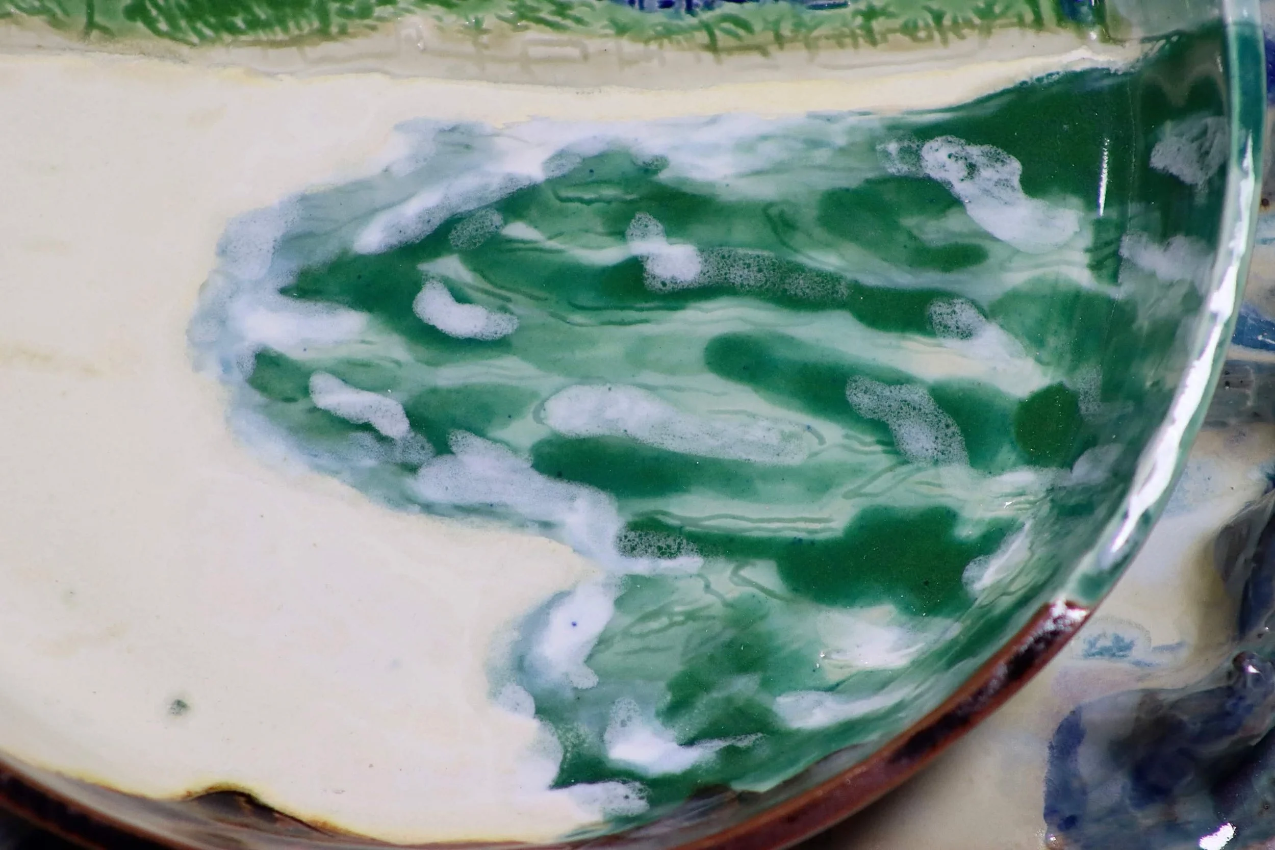 "My Rushing Waves of Culture III" 2026.  Glazed Porcelain. 11" x 8" inches.  Part of a series.  A ceramic plate of Miami Beach's shoreline on a tray in the form of ocean waves.