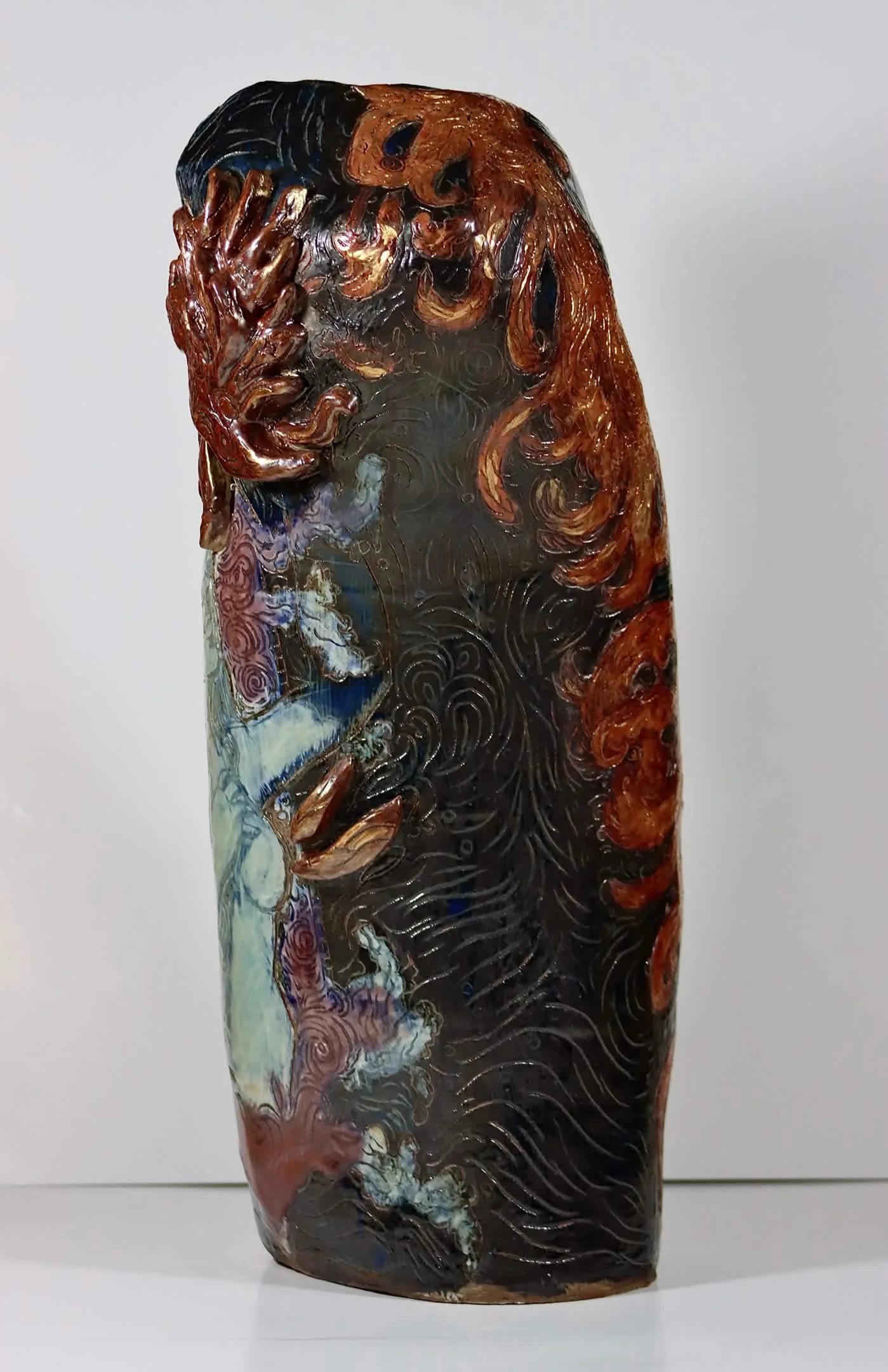 “Rebirth”, 2025. Red stoneware clay with sgraffitto,  black and porcelain slips, malcolm shino, red irwing, peach bloom 2, cuba's beaches, purple haze, and gold acrylic paint.
9" x 23" inches. 
The ceramic vase displays a narrative story of rising fr