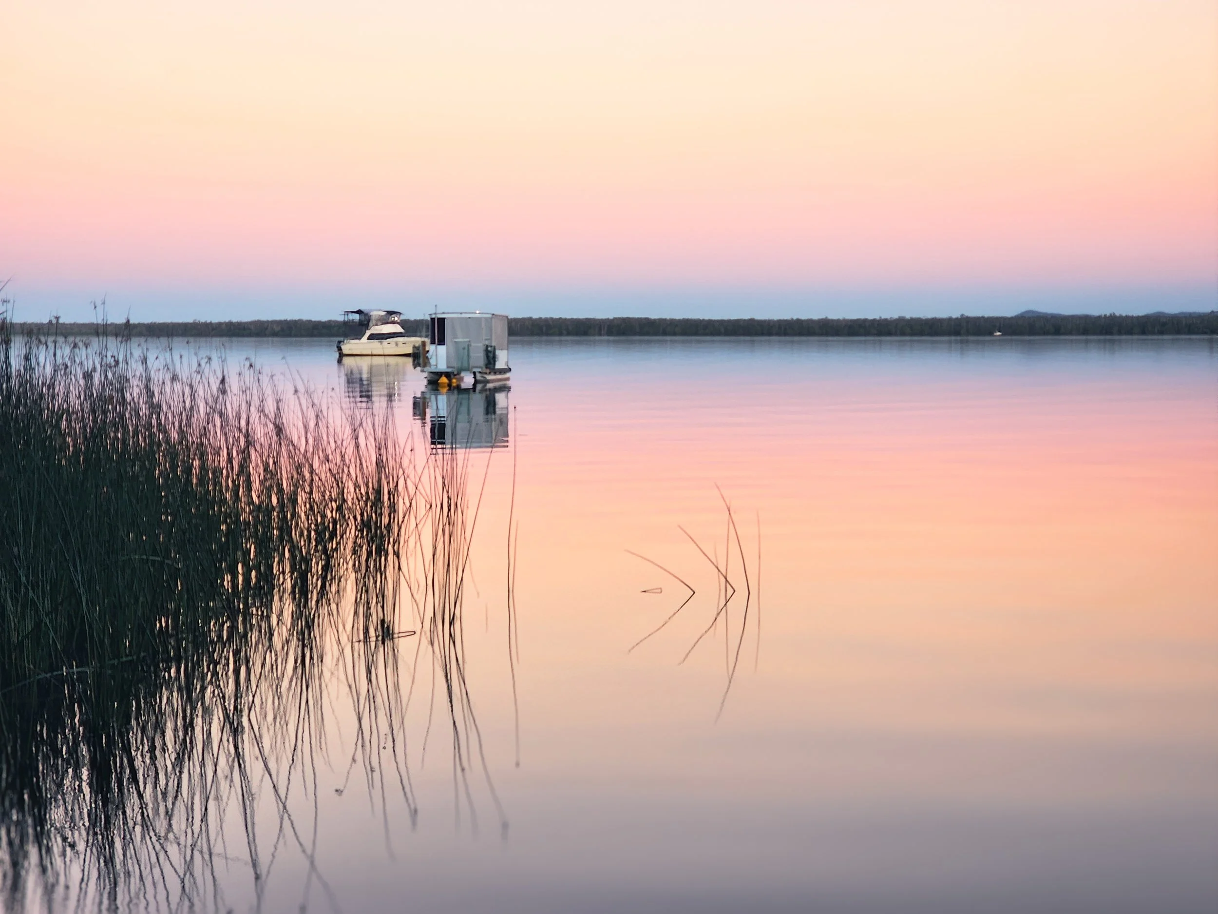 An illustration of the sun partially covered by white clouds against a black background.