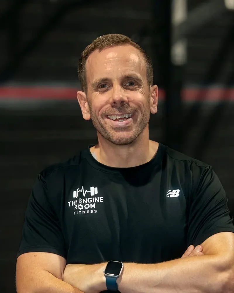 Colin Gayer, co-founder and coach at The Engine Room Fitness, arms folded and smiling