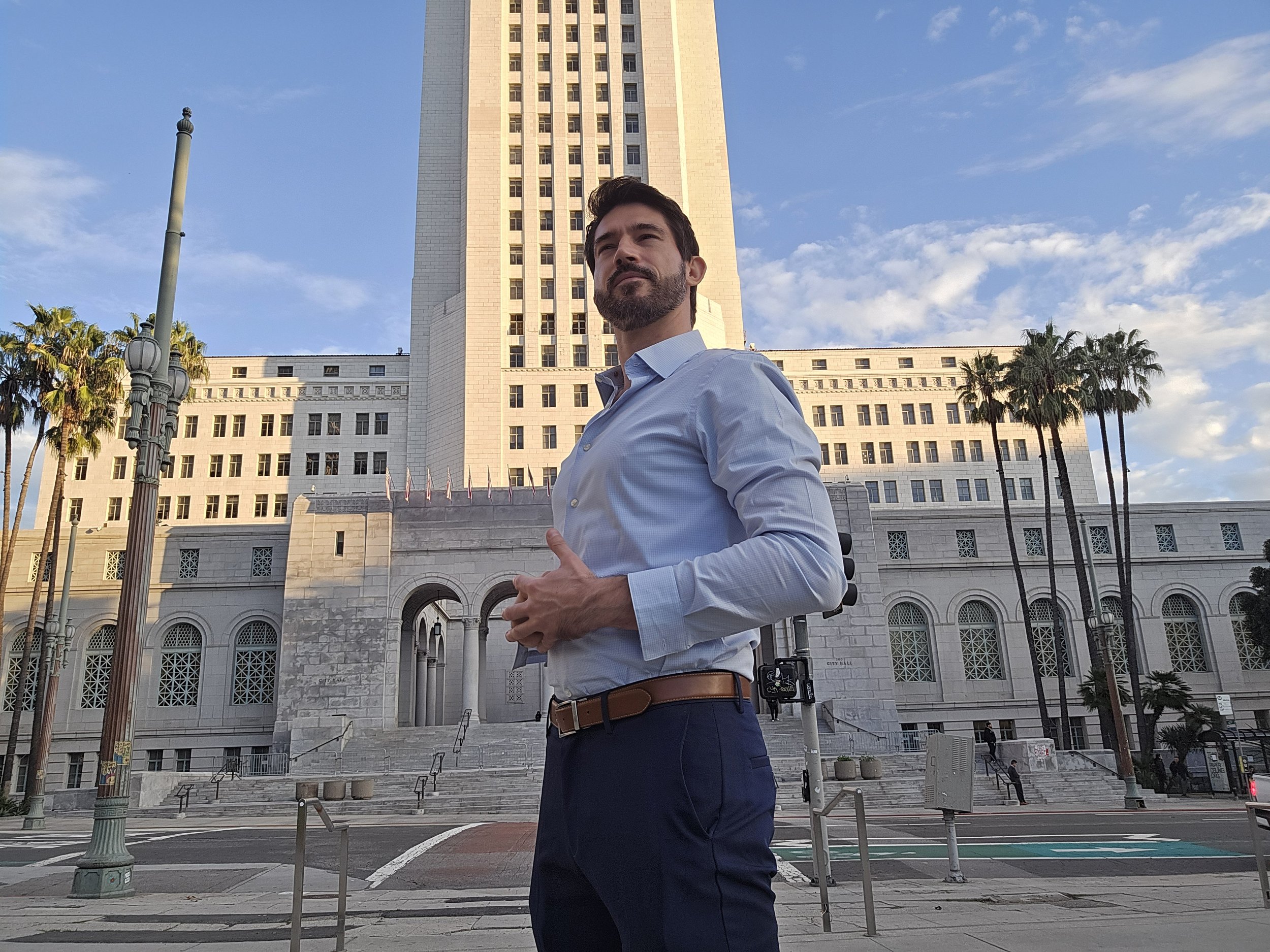 Andrej Selivra standing in front of Los Angeles City Hall
