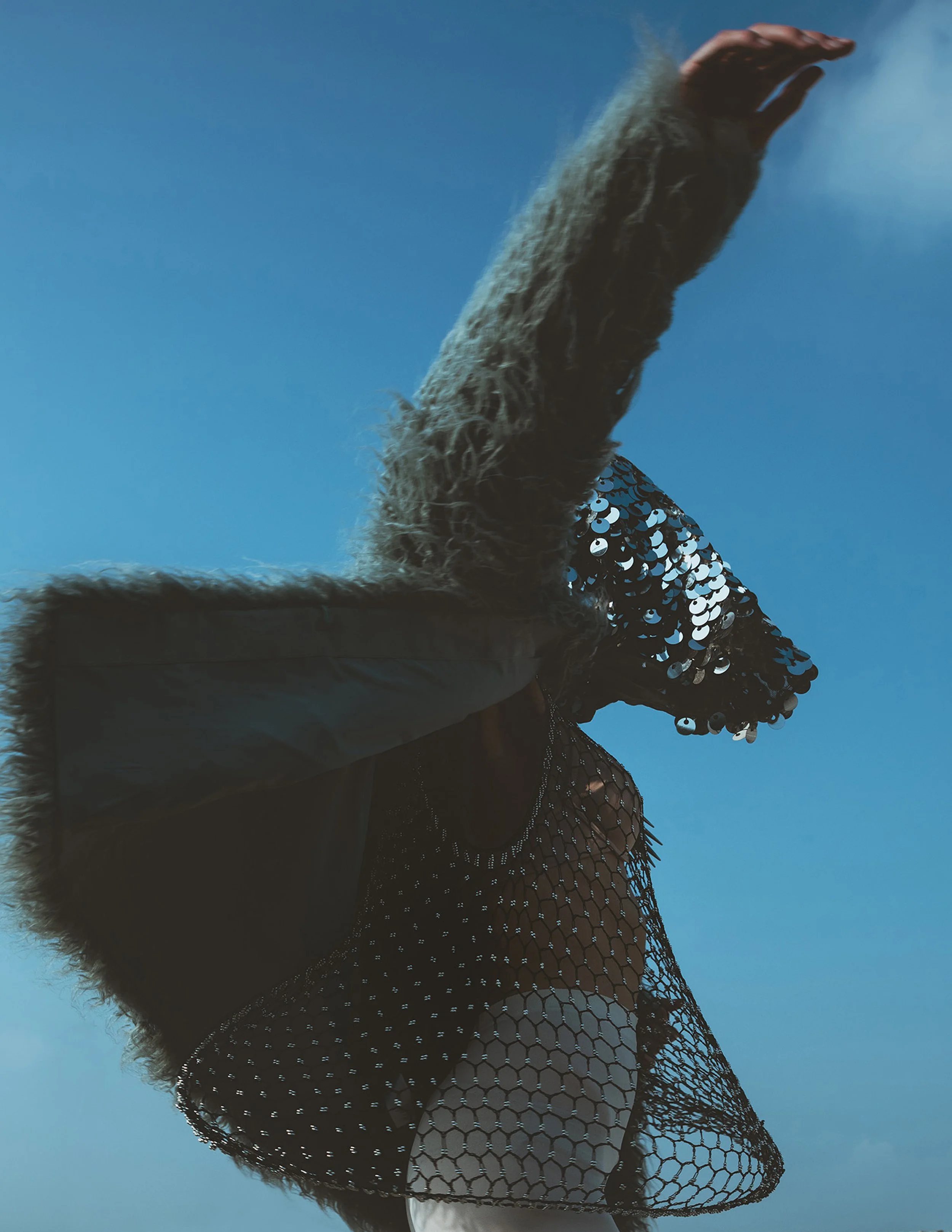  Wardrobe Credits:   Blue Faux Fur Jacket – H&amp;M  White Tights – Selfridges &amp; co  Metallic Necklace - Topshop  Netted Mesh Top - Bianca Fyre  Headgear by Henna Parimoo 