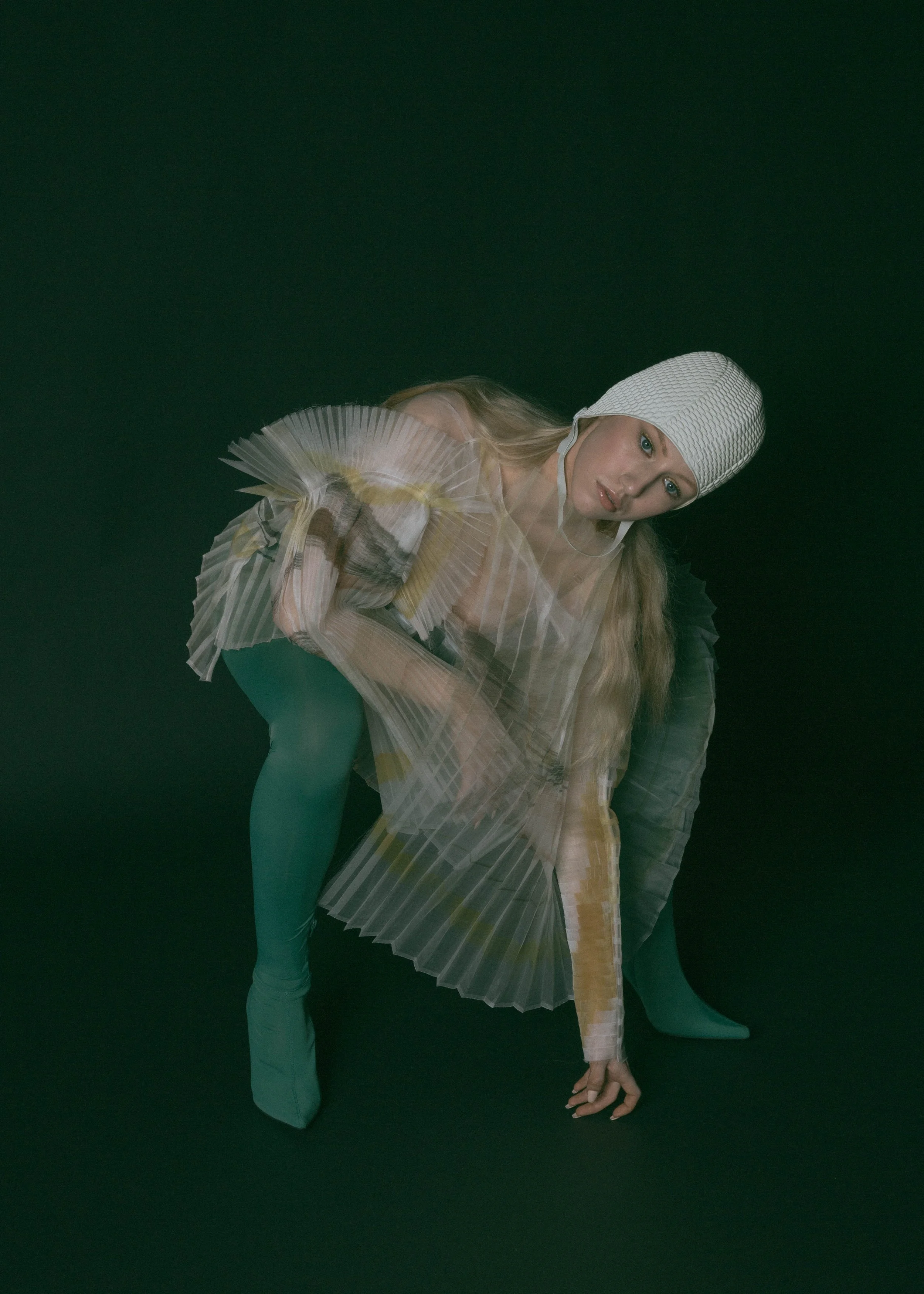  Wardrobe Credits:  Painted Asymmetric Pleated Blouse/ Shanshan Ruan Swim bathing cap/ Beemo Gloves/ Stylist own 