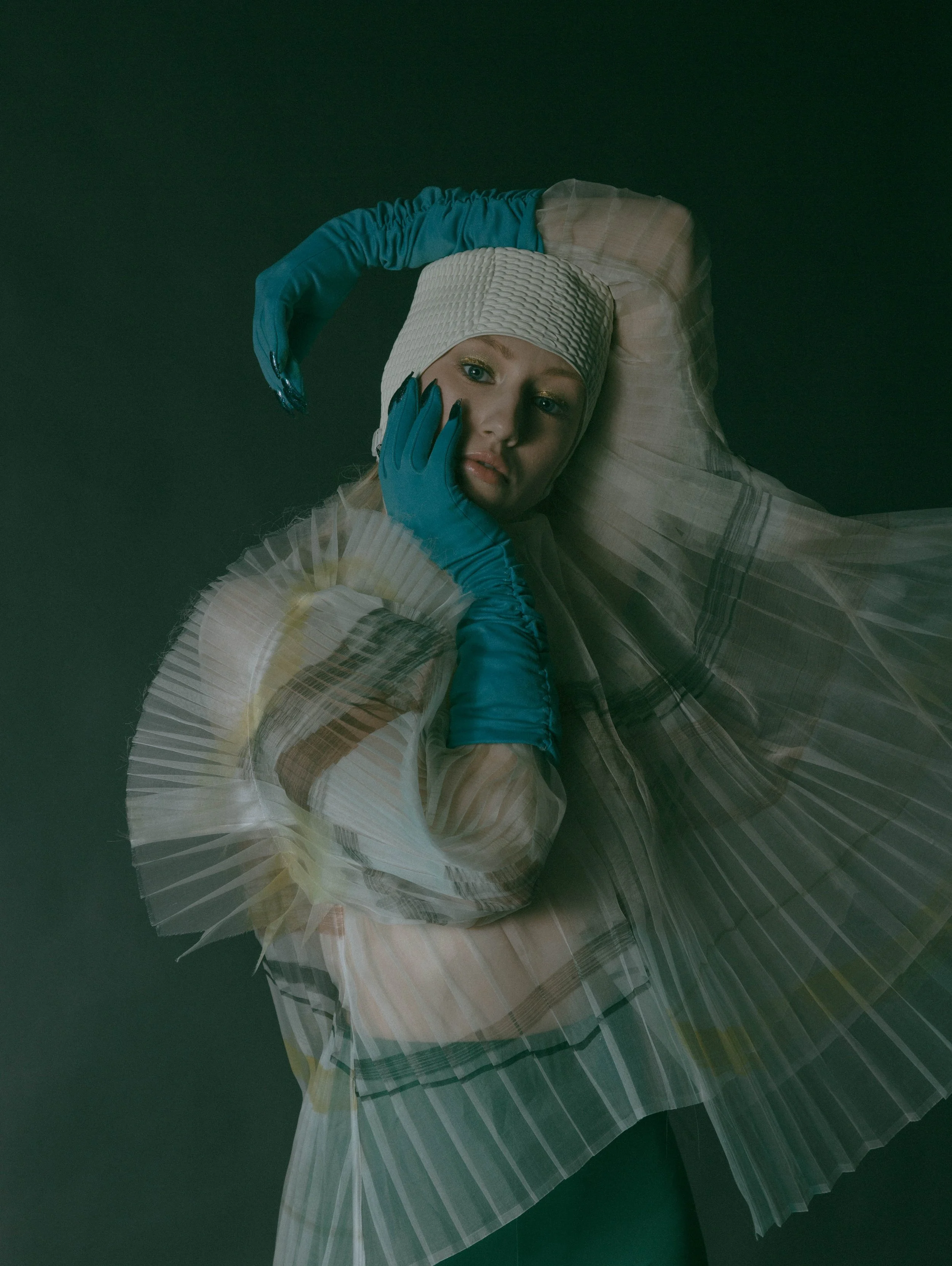  Wardrobe Credits:  Painted Asymmetric Pleated Blouse/ Shanshan Ruan Swim bathing cap/ Beemo Gloves/ Stylist own 