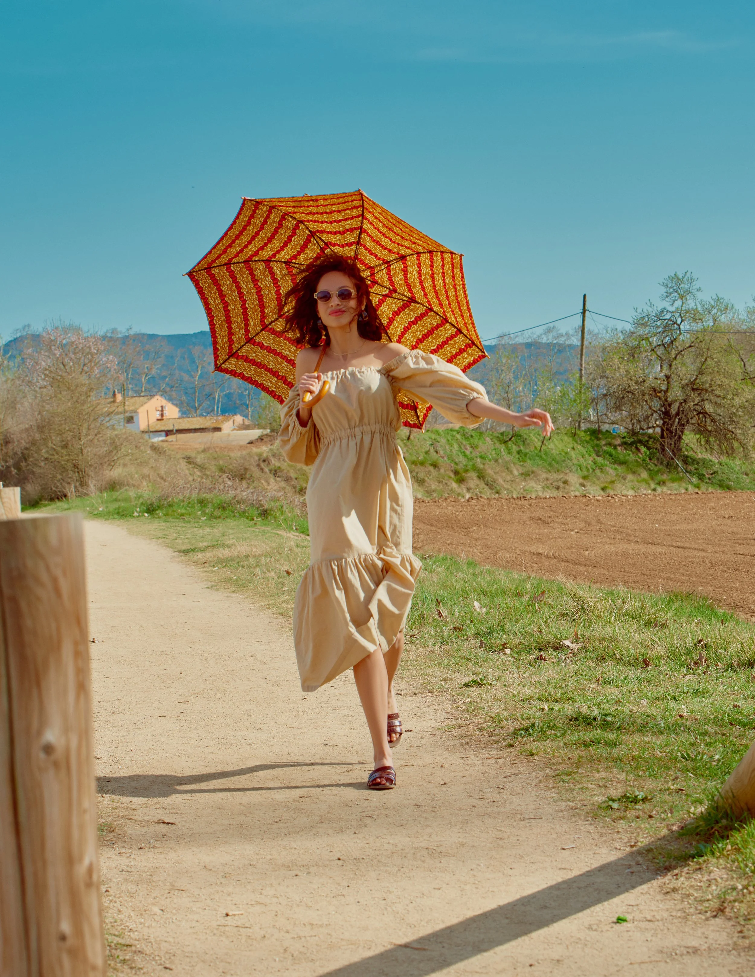  Photographer: David Garcia  Model: Sabrina Sancler @ Lenis  Makeup Artist: Vanessa Crespo  Wardrobe Stylist: Aina Caballero  Assistant: Mike F. Pamphile    Dress: Nea Badson  Sandals: Stileo  Eyewear: Junior Gaultier  Umbrella: Colibantun 