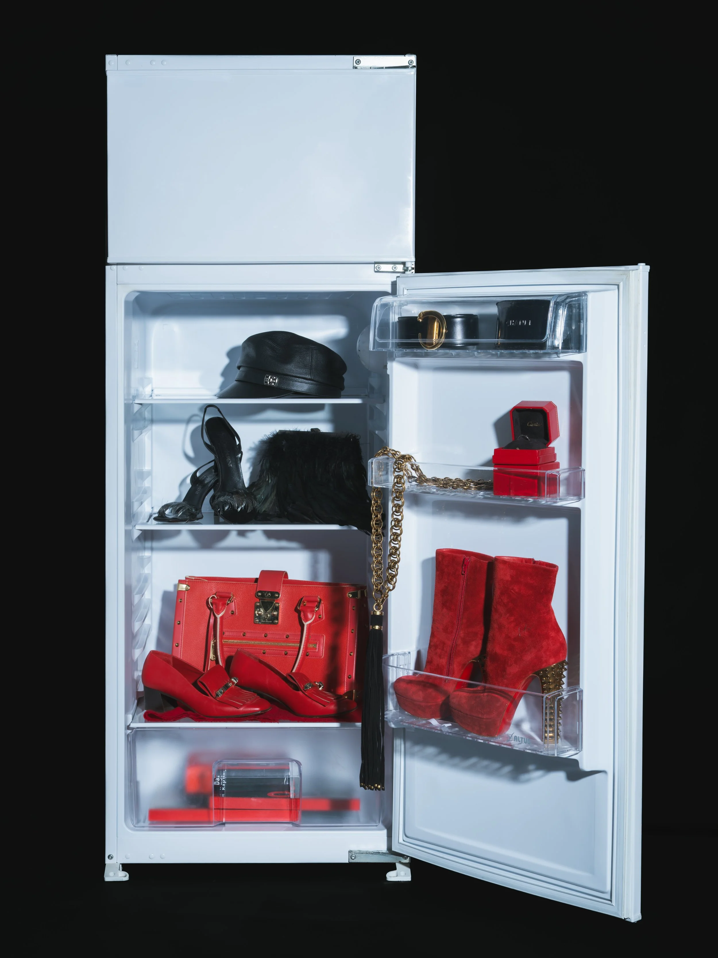 Starting at the top of the main compartment: Gucci Hat, YSL Heels, Feather Bag is Stylists own, Red pumps are Valentino, Bag is Louis Vuitton Going on the top of the door compartment: Cartier Belt, Chanel Glasses, Gucci Belt, Cartier Ring, Louboutin