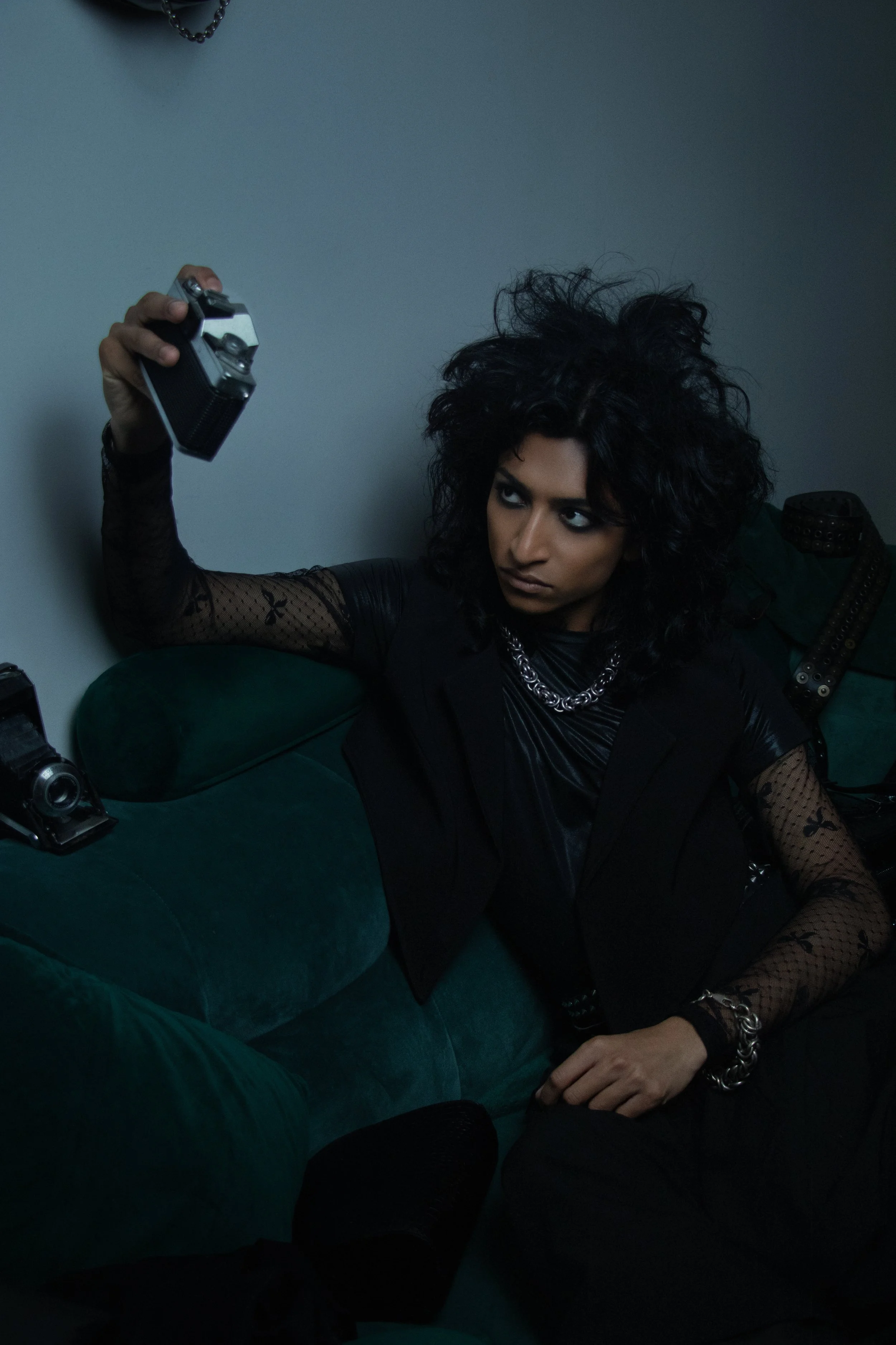 Dark tailoring, heavy chains, and untamed texture create a cinematic grunge silhouette