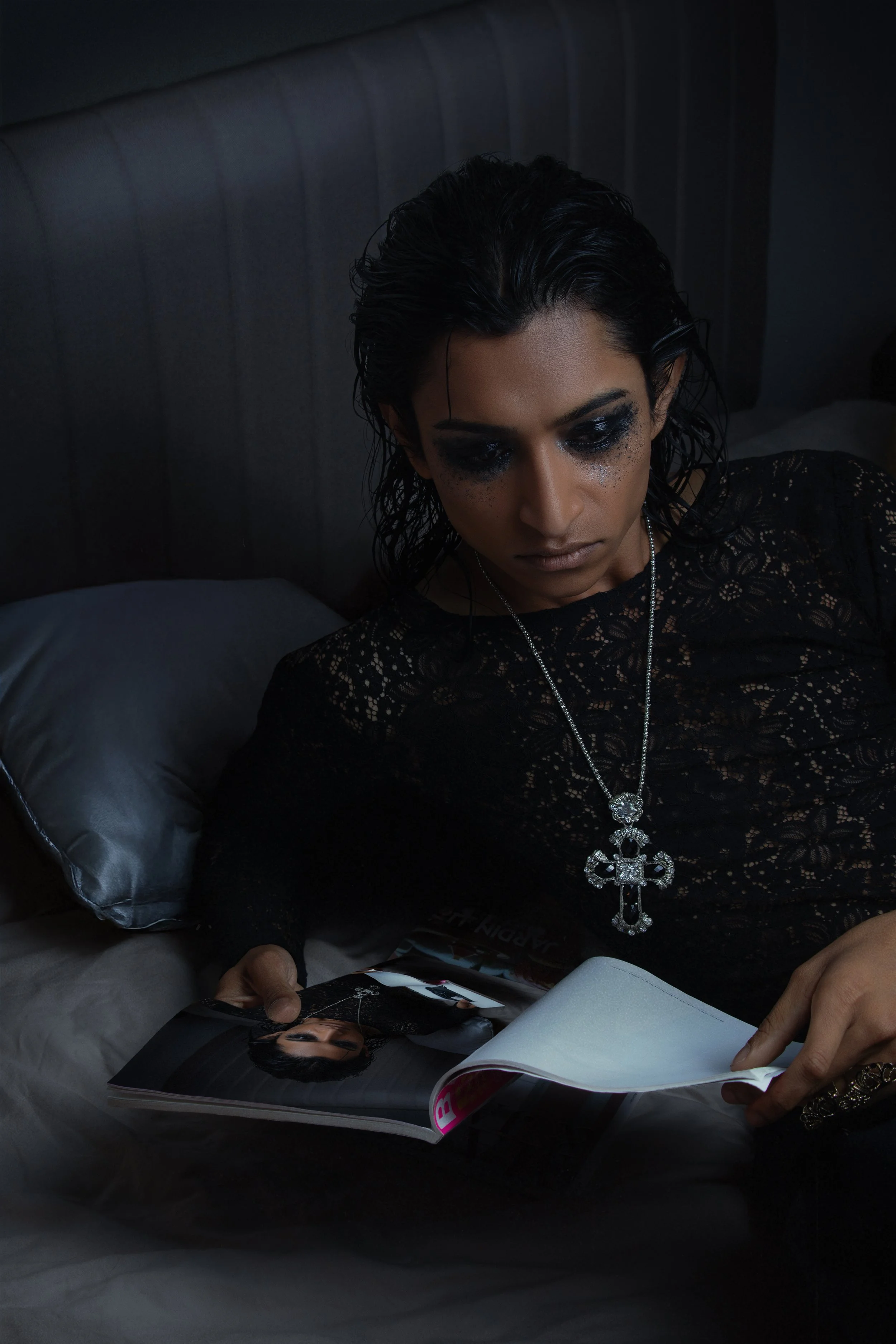 Wet texture, lace, and smudged glitter eyes create a dark, intimate glamour