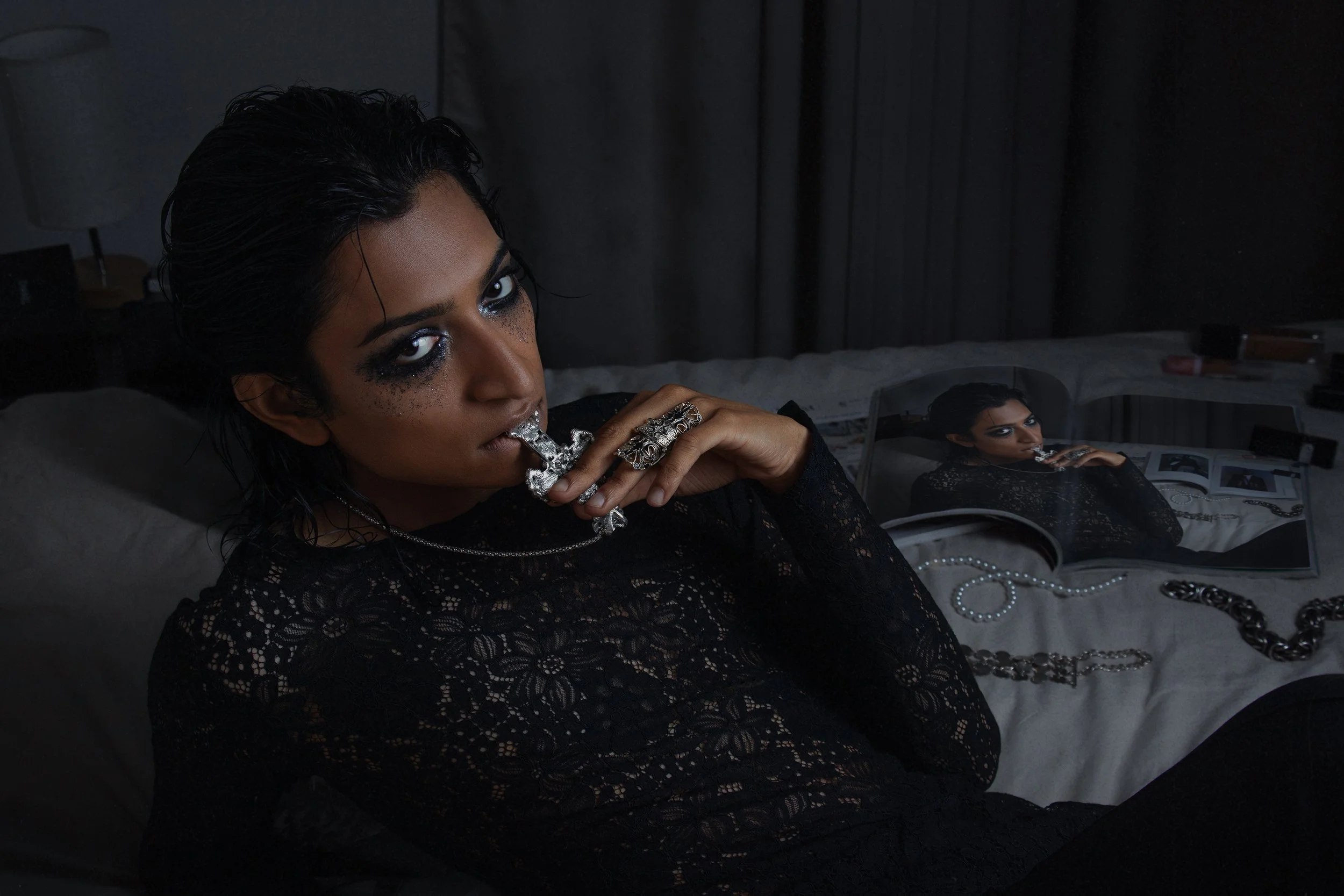 Heavy jewelry and smeared makeup blur the line between beauty and rebellion