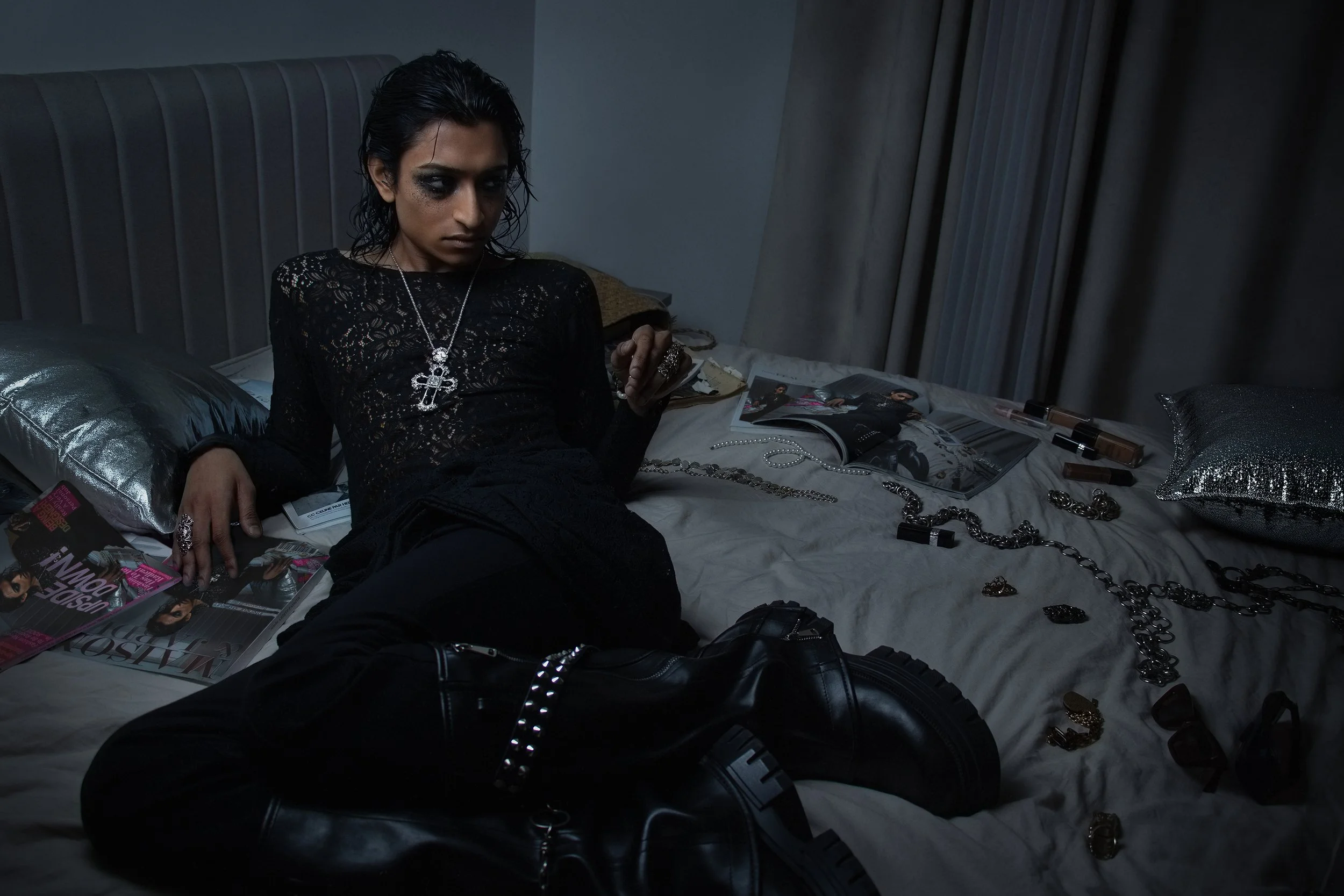 Chunky boots, silver details, and shadowy lighting bring a raw post-party attitude to the scene