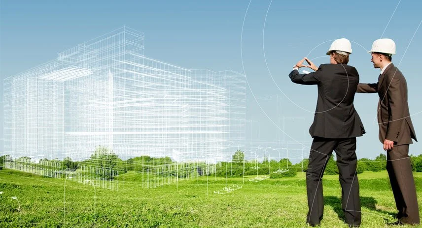 Two professionals in business suits and hard hats standing on a grassy field, one taking a photo of a digitally rendered building on a blueprint overlay, with a blue sky and green trees in the background.