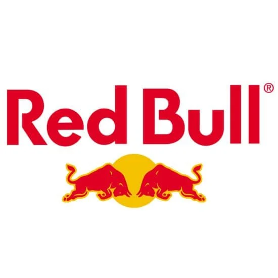 Red Bull logo with the brand name in red text above two red bulls facing each other, set against a yellow sunburst background.