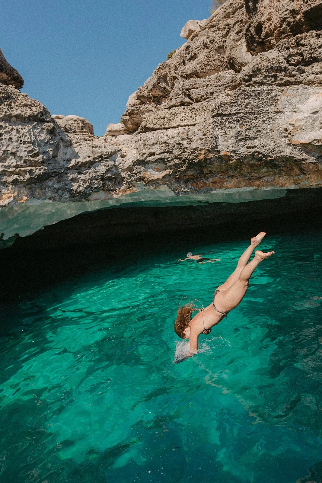 Woman jumping in turquoise water.jpg