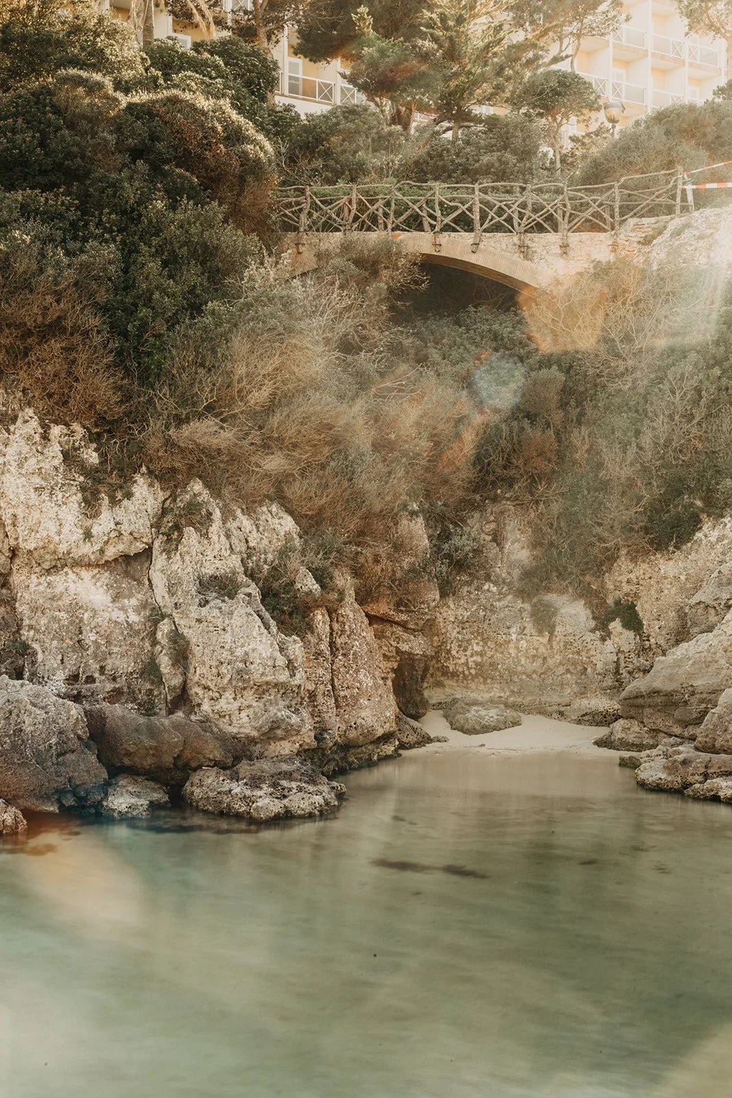 Peaceful cove in Menorca with crystal-clear water and natural surroundings