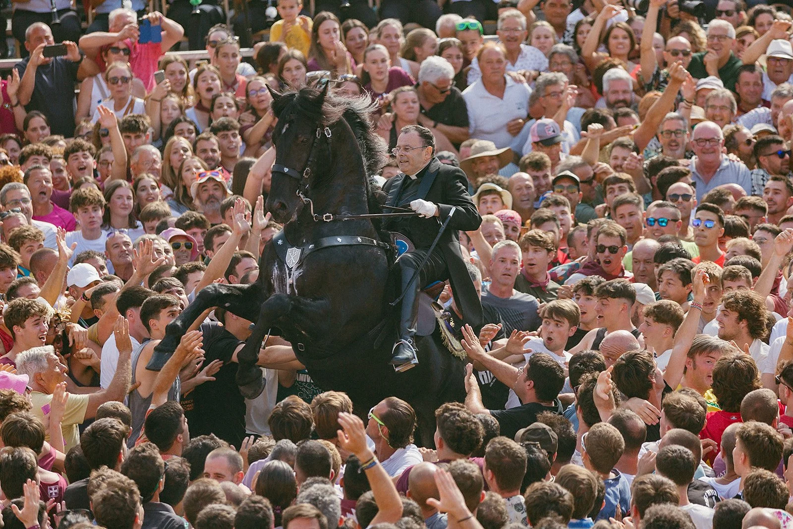 Caixer Capellà on a rearing horse in Ciutadella, Menorca, during the Caragol des Born, one of the most spectacular events of the Sant Joan festival