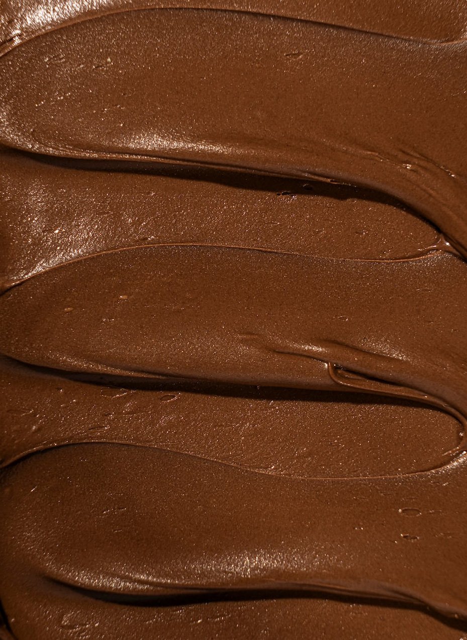 Close-up of smooth, melted chocolate with a glossy finish.