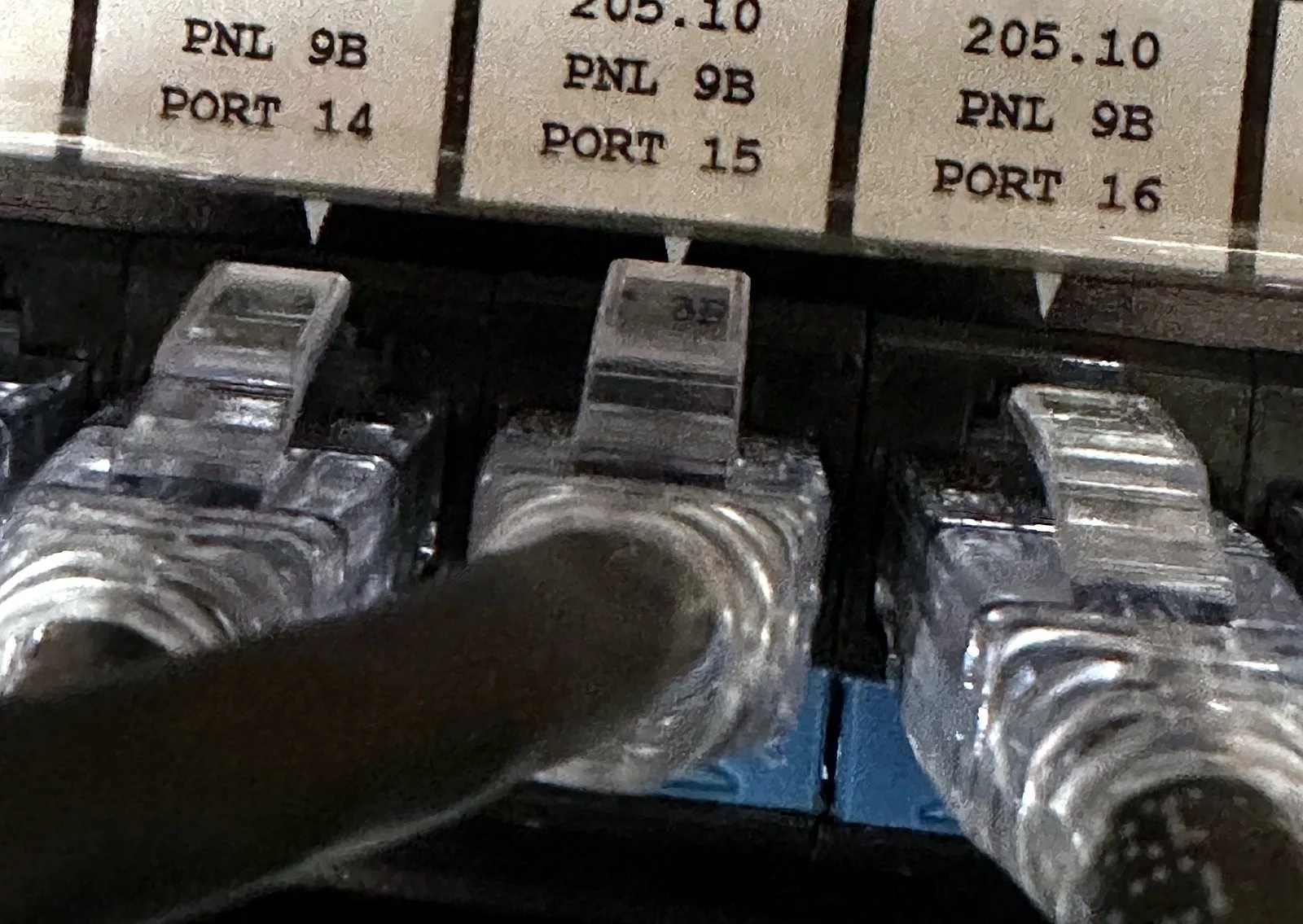 Patch panel ports labeled by cabinet, panel and port number