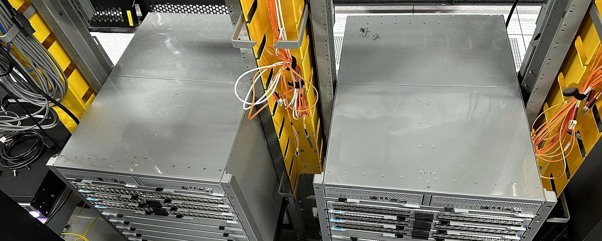 Pair of modular switch chassis staged on a raised floor before install