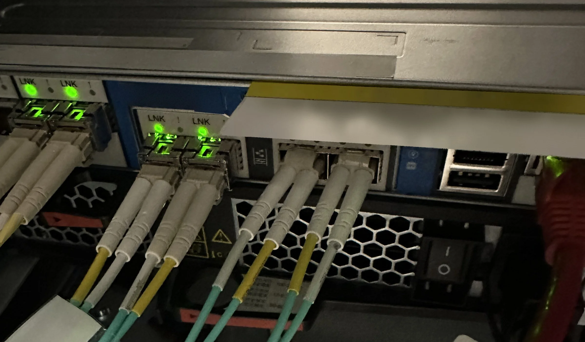 LC fiber seated in storage controller ports with green link lights on a Philadelphia field dispatch