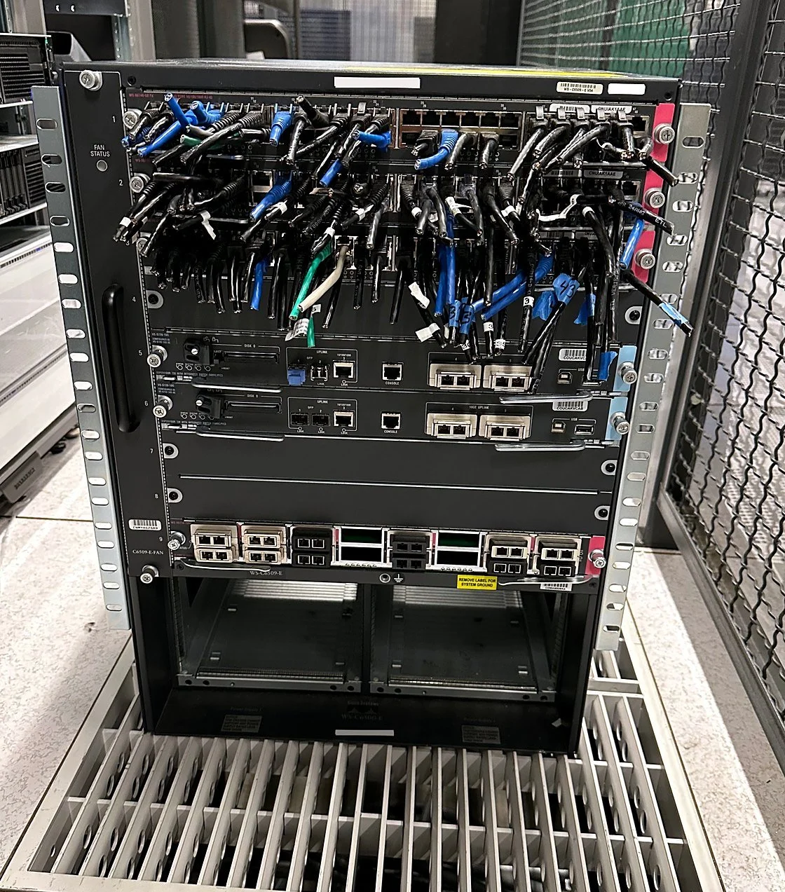 Decommissioned Cisco Catalyst 6509-E chassis pulled from service with its patch cords still in the line cards