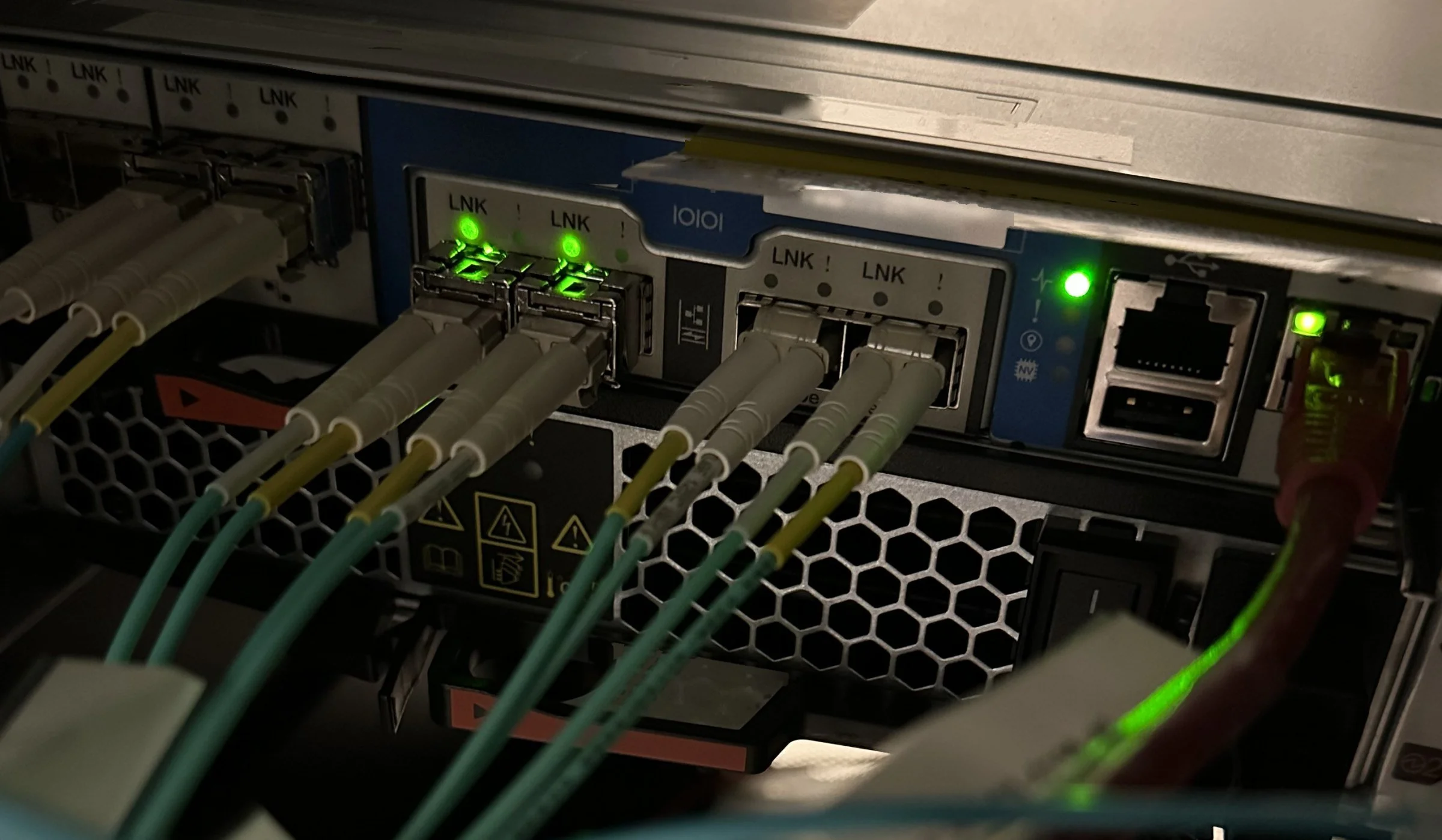 Multimode fiber patched into NetApp storage controller ports with link lights on, Center City Philadelphia job