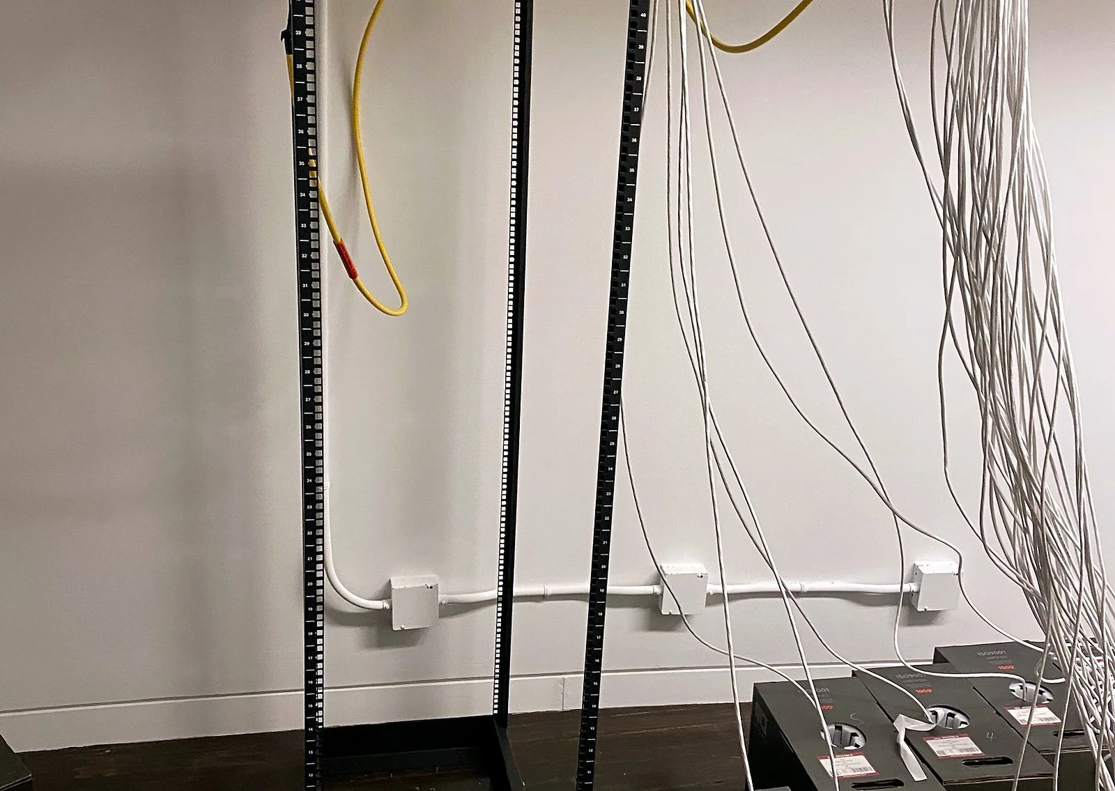 Open frame rack with new cable runs dropped from the ceiling
