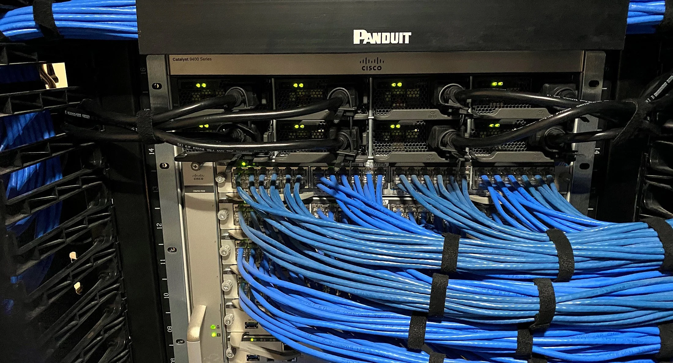 Cisco Catalyst 9400 switch with blue Cat6 patching bundled into Panduit cable managers