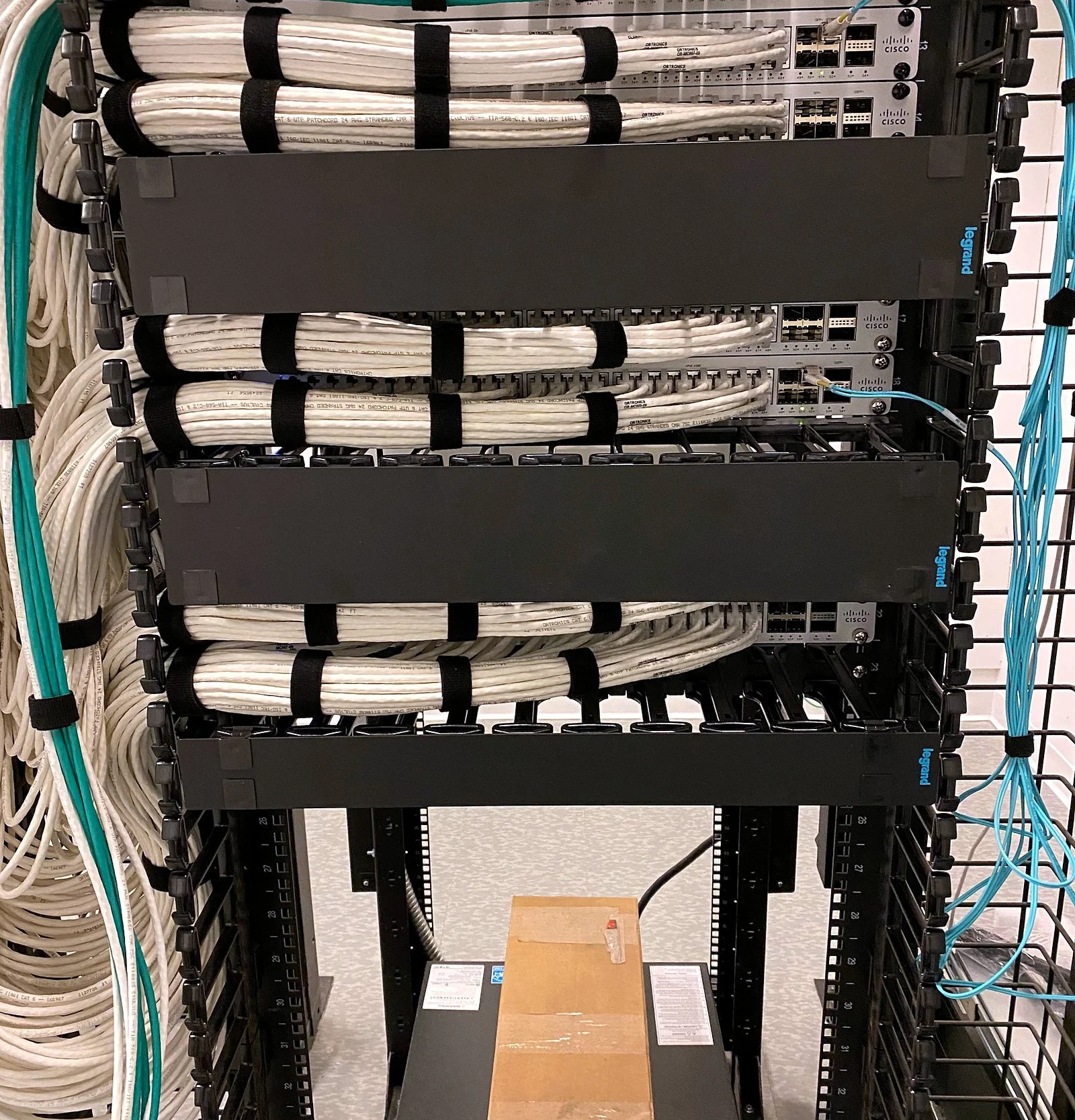 Rack with white cable management and patched devices
