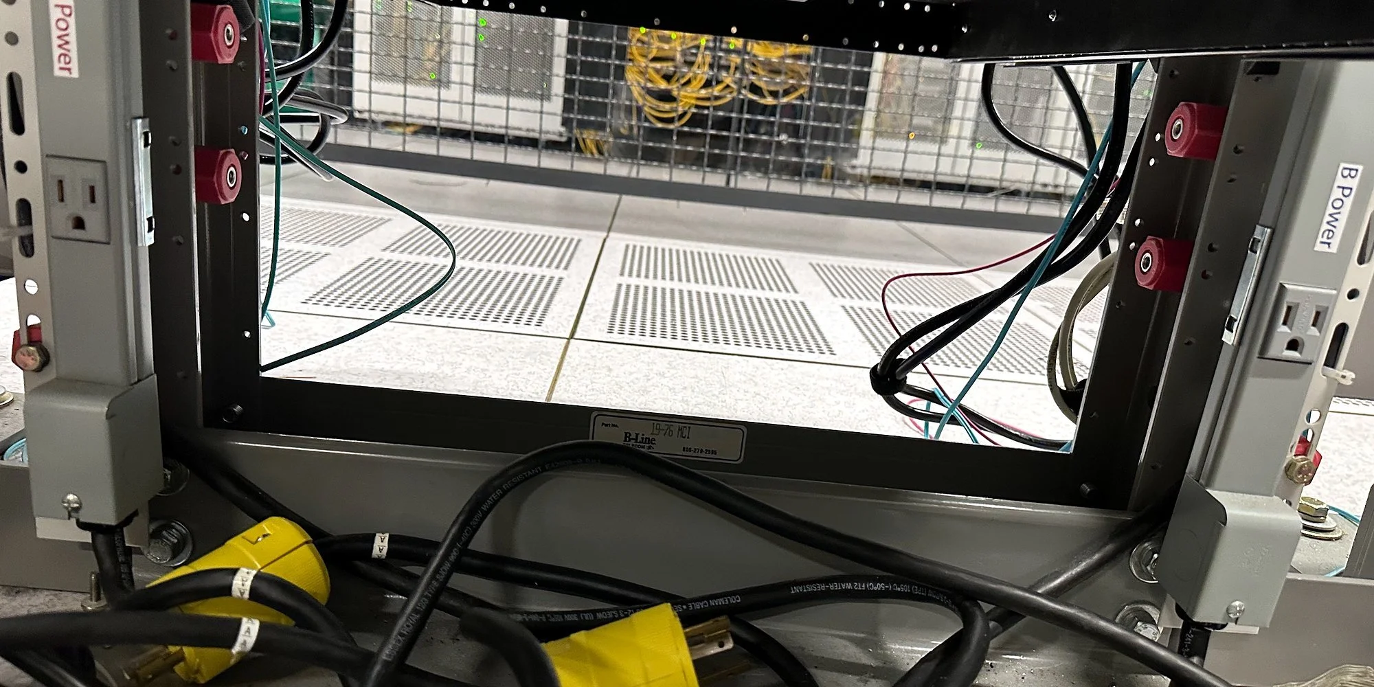 Underfloor power whips with twist-lock connectors feeding a cabinet