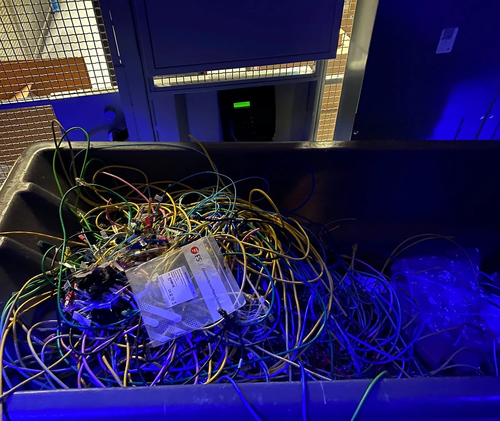 Pulled fiber collected in a bin during equipment decommissioning