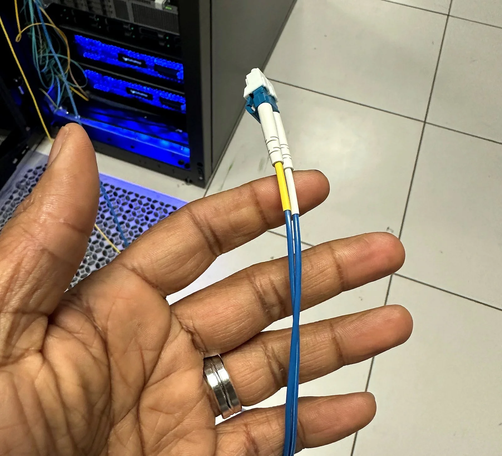 Technician holding a fiber patch cord
