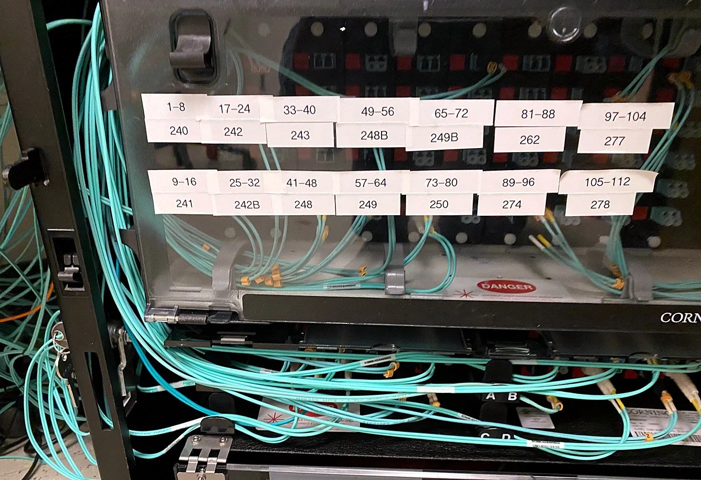 Corning fiber enclosure with labeled port ranges and aqua multimode patch cords