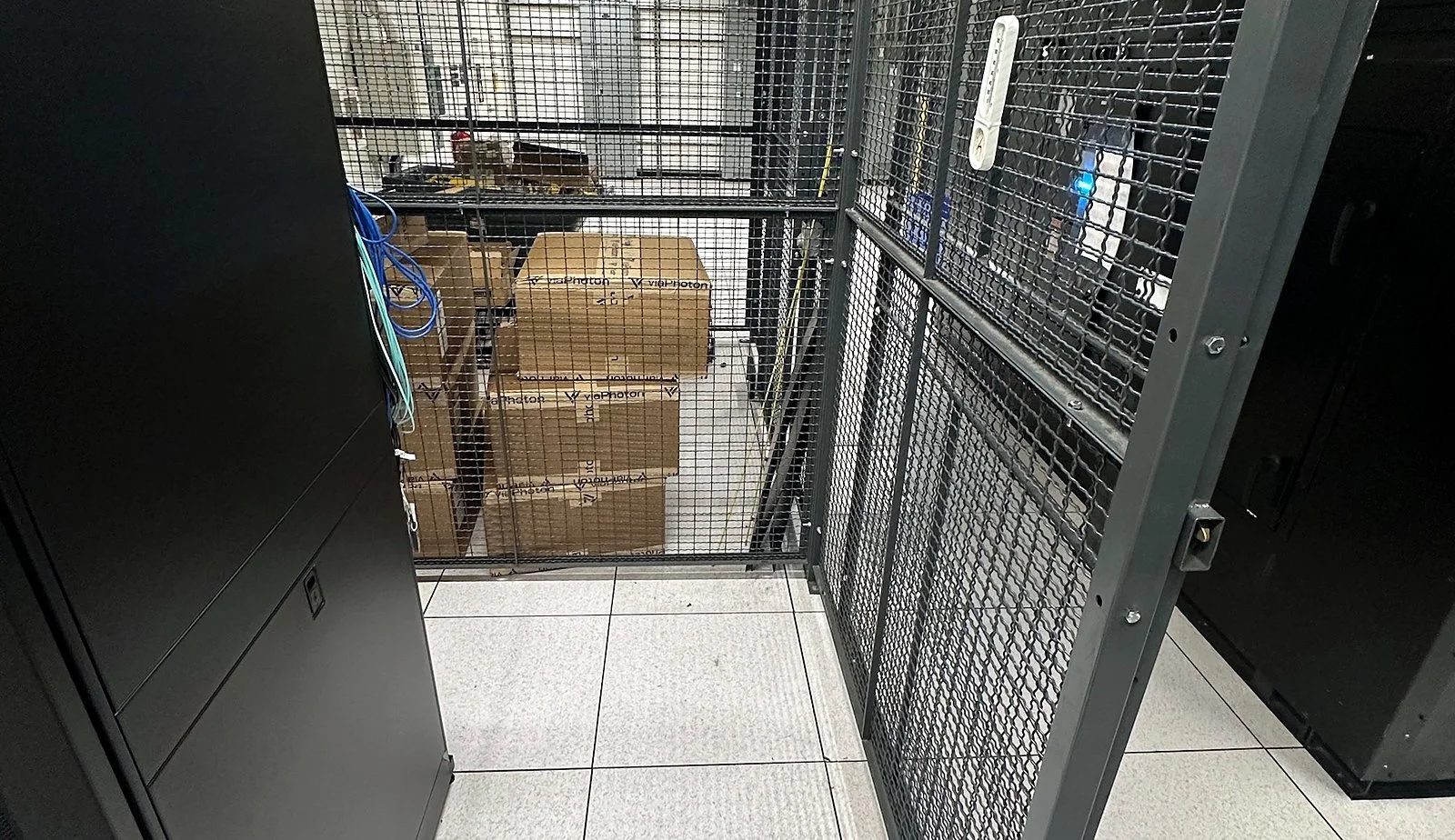 Data center colocation aisle with cage cabinets
