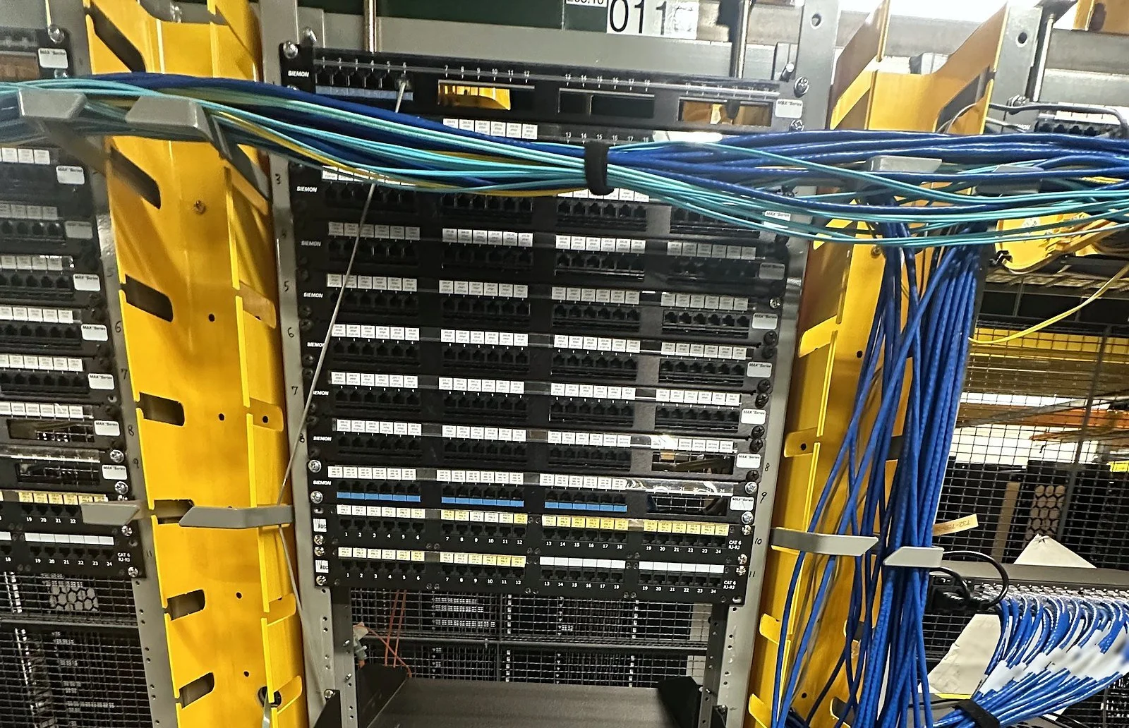 Patch panels and cross-connect cabling in a colocation cage rack