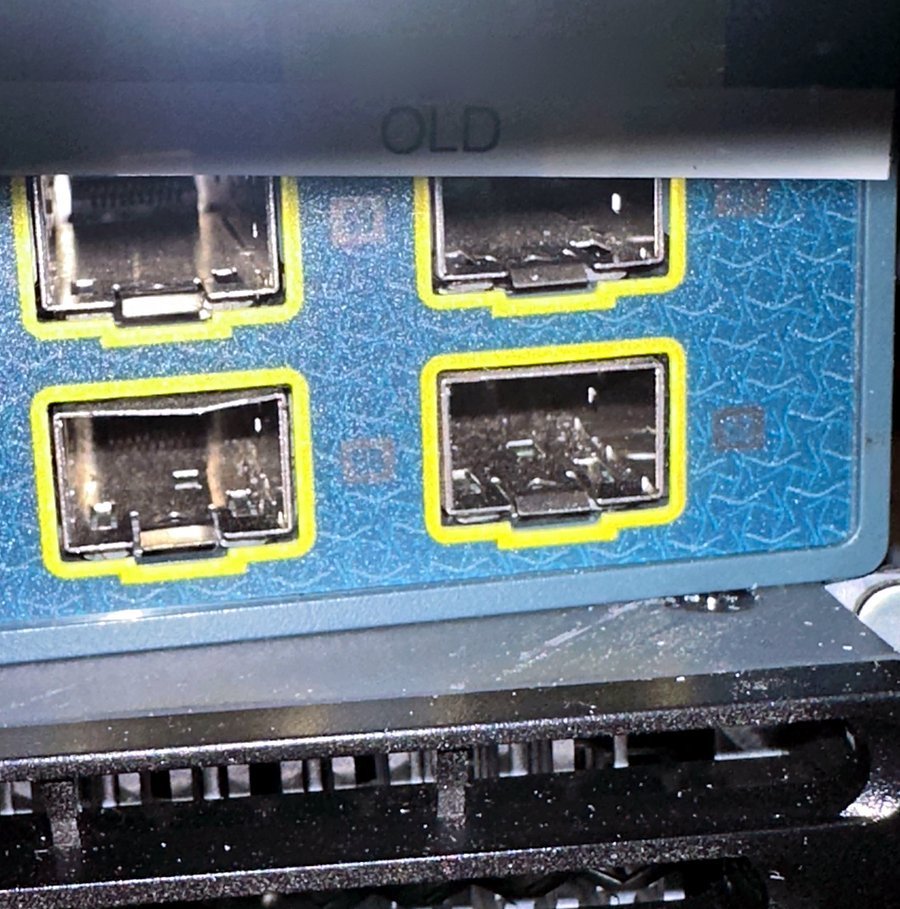 Retired Cisco Catalyst switches tagged OLD and staged for decommission