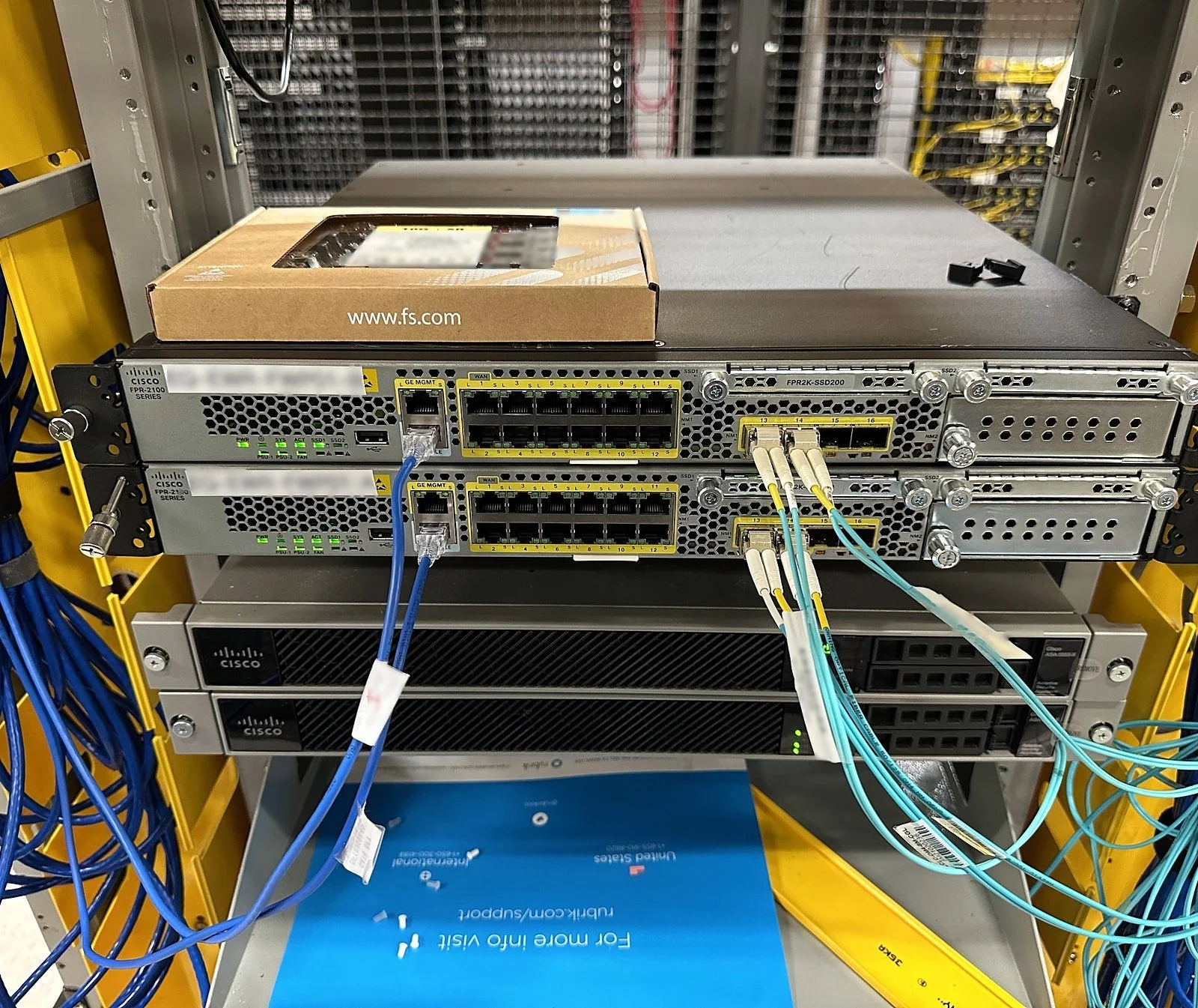 Network devices racked with fiber and Cat6 connections