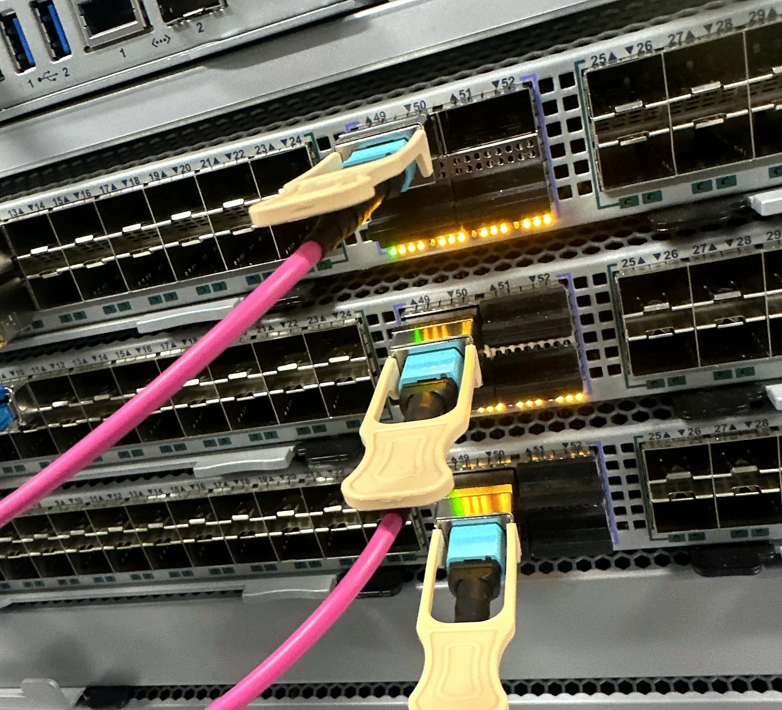 Arista switch with pink fiber jumpers and transceivers
