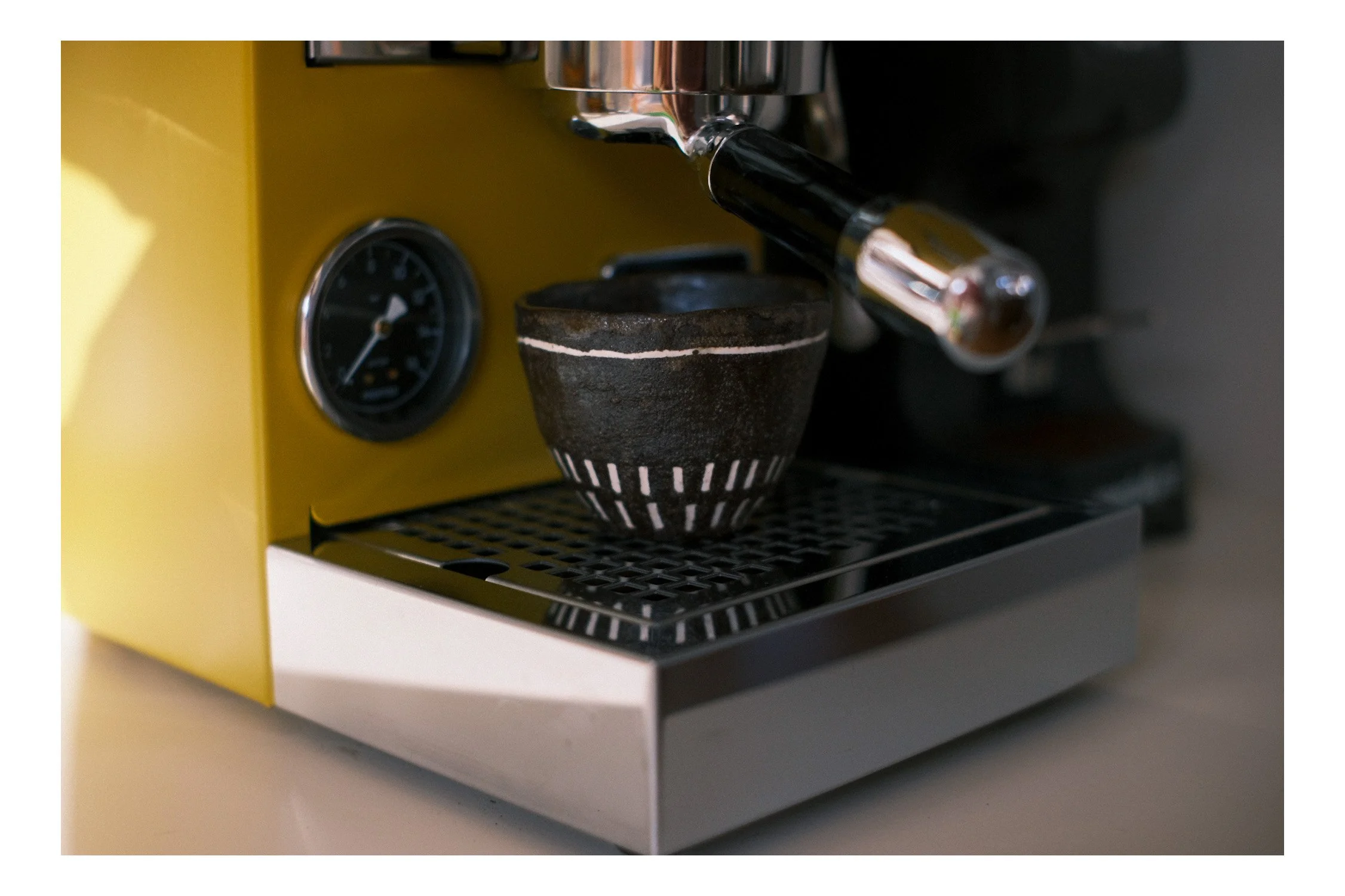 An image of a hand made coffee cup with espresso machine..