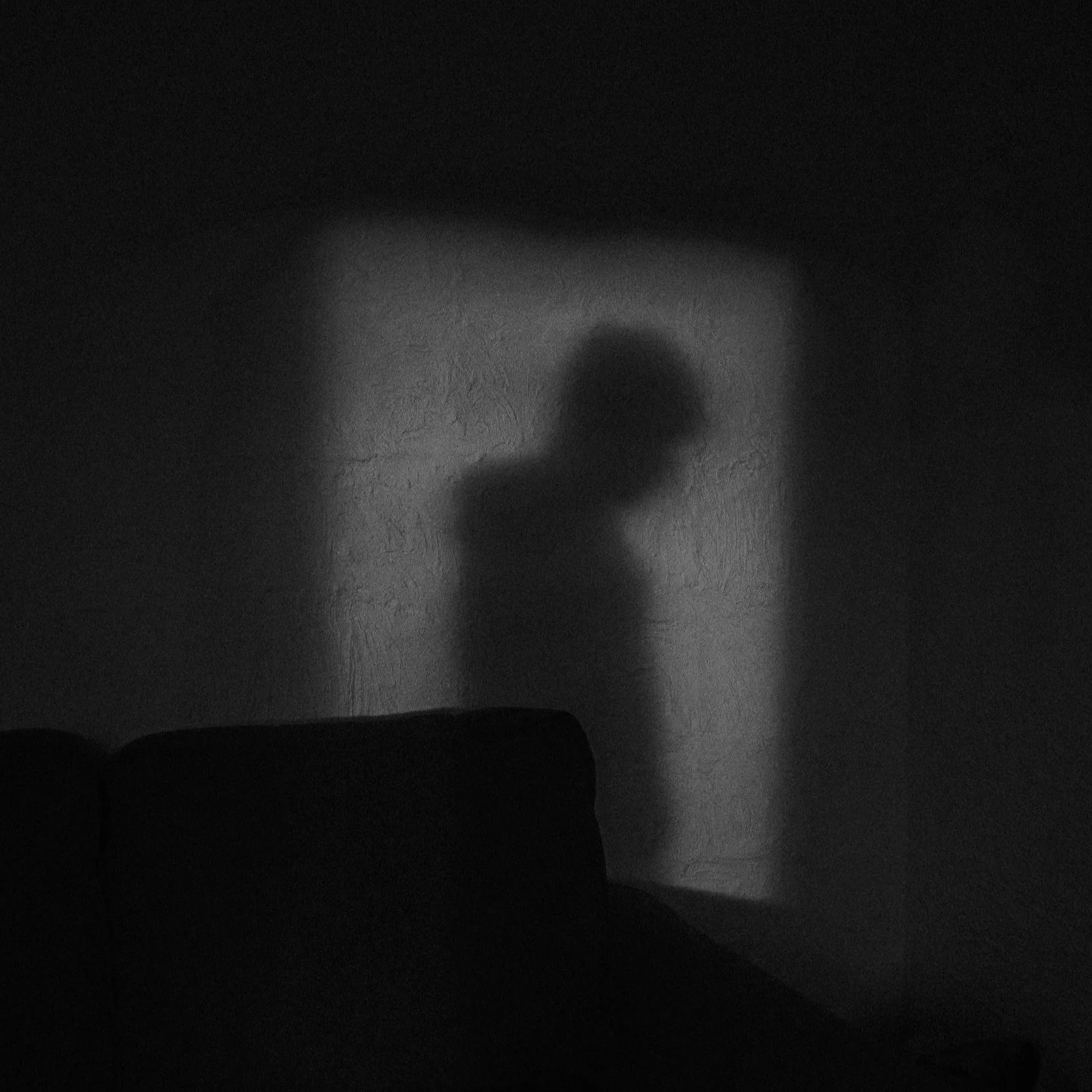 Geometric drawing of an outline square with sections divided by vertical, horizontal, and half circle lines.