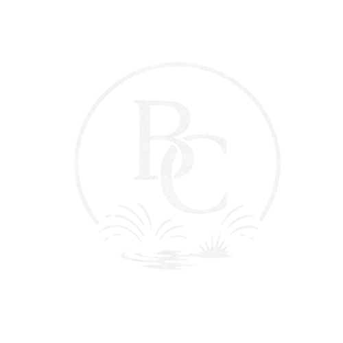 The letters B an C intertwined sitting above a pond