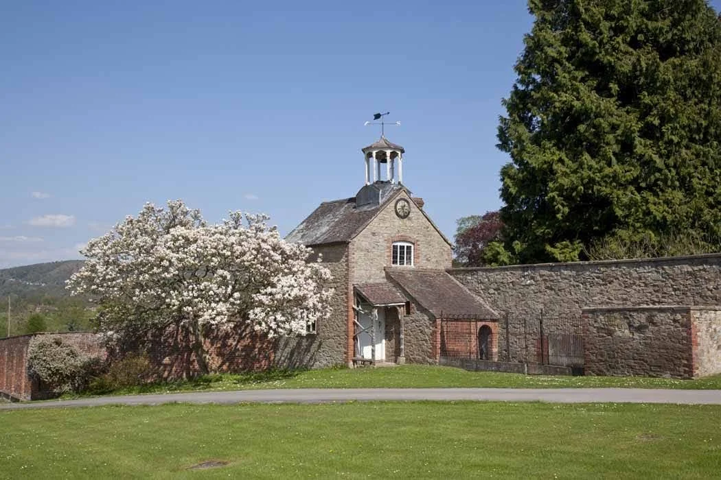 A detached period cottage with a clock tower