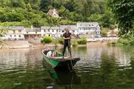 Man operating a hand ferry across the river